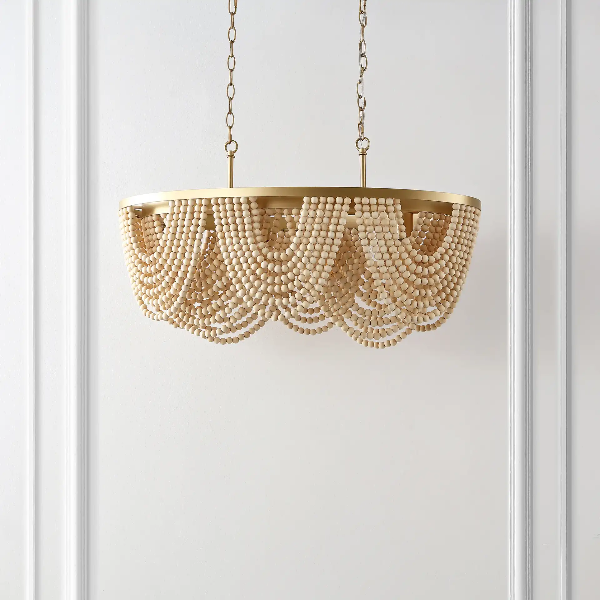 Alluri Four-Light Chandelier in Gold / Natural in a styled room