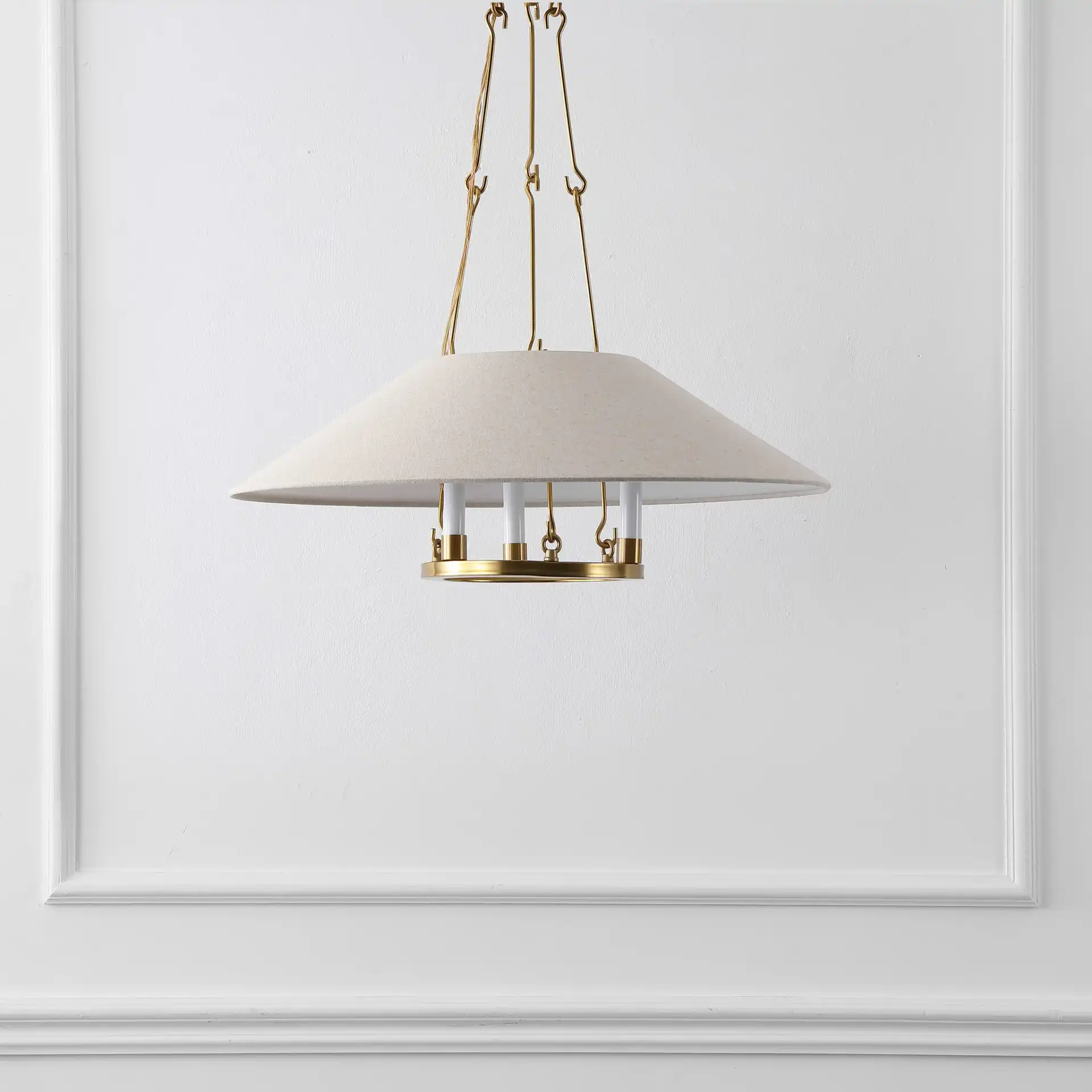 Pamila Three-Light Chandelier in Brass in a styled room