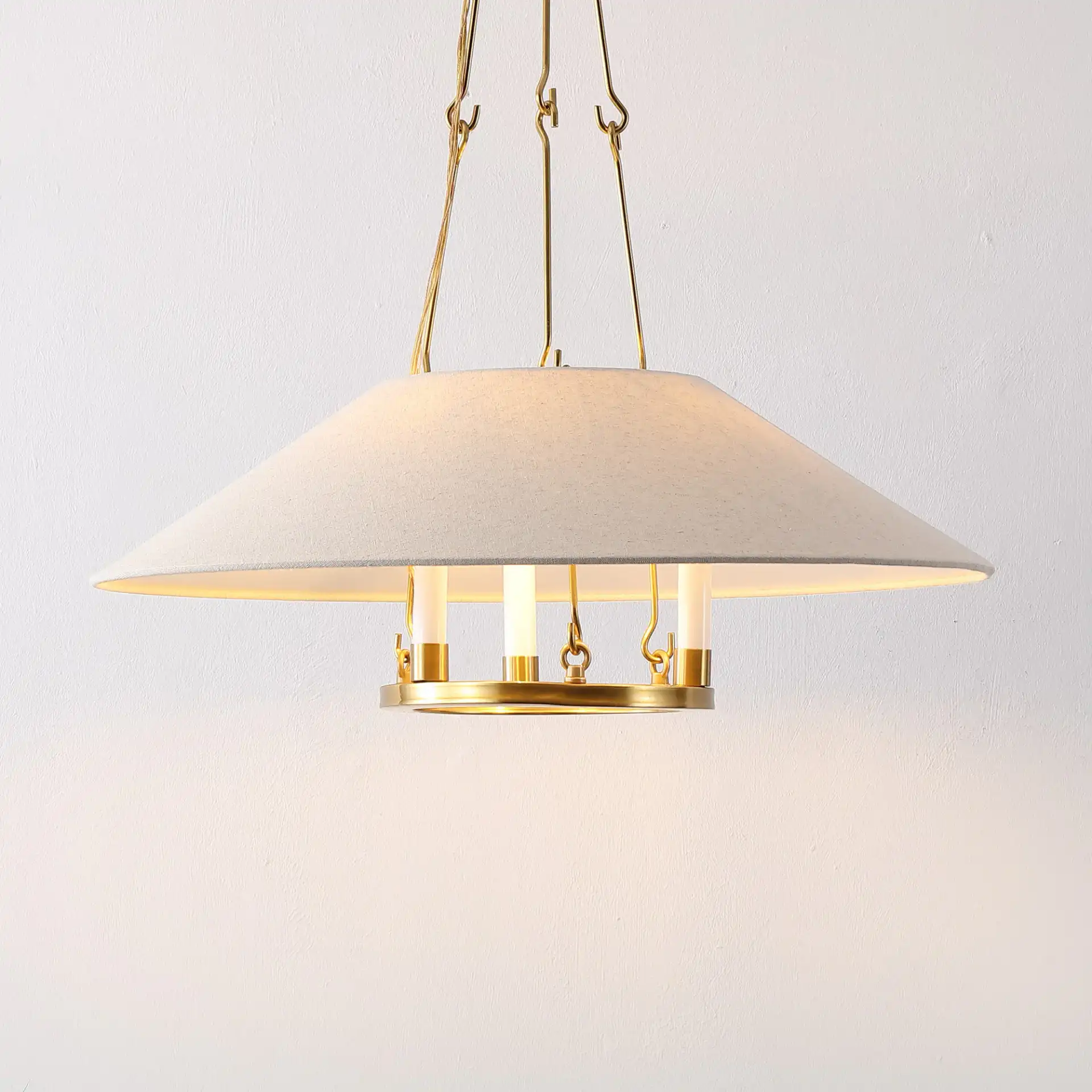 Pamila Three-Light Chandelier in Brass in a styled room