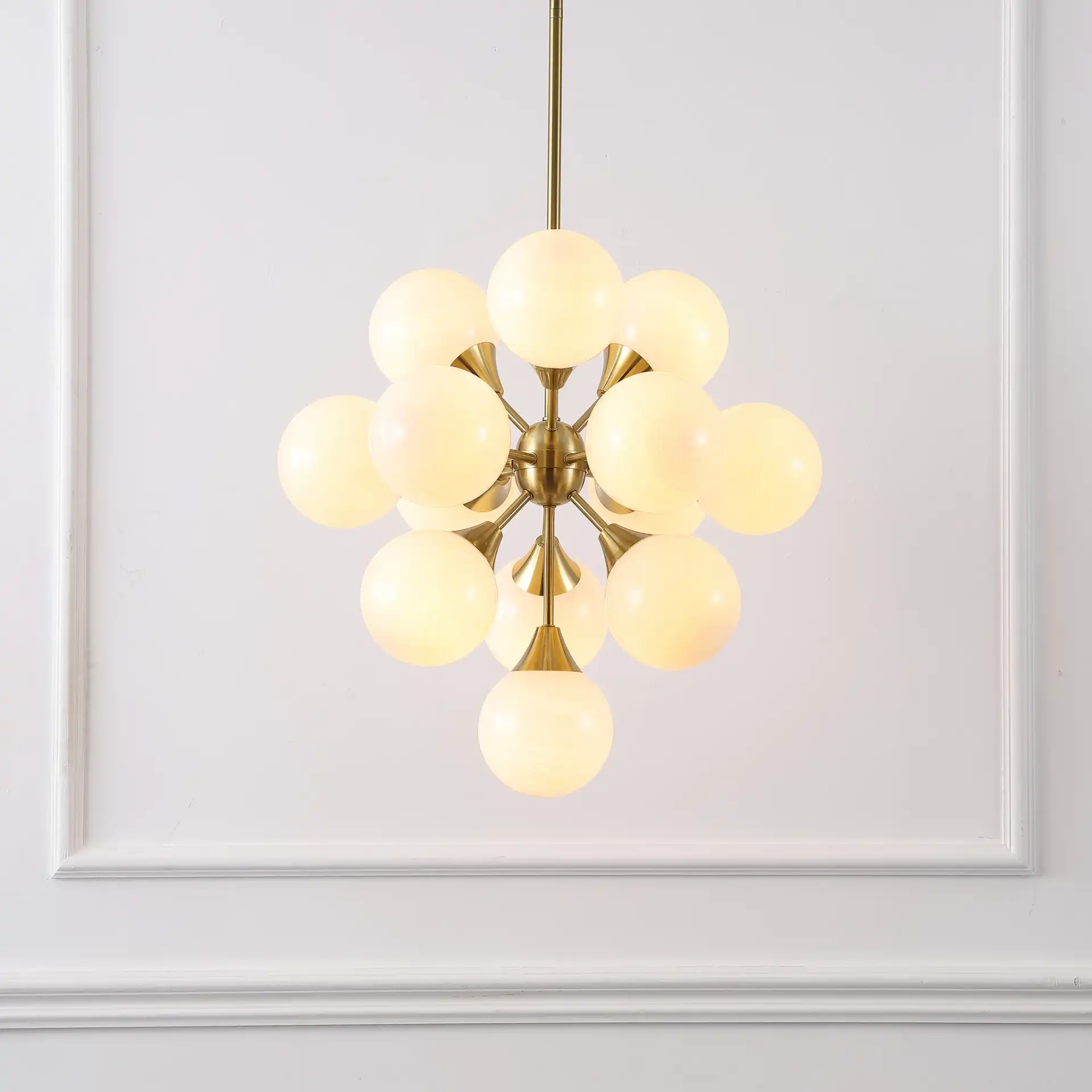 Delvine Thirteen-Light Chandelier in Brass / White in a styled room