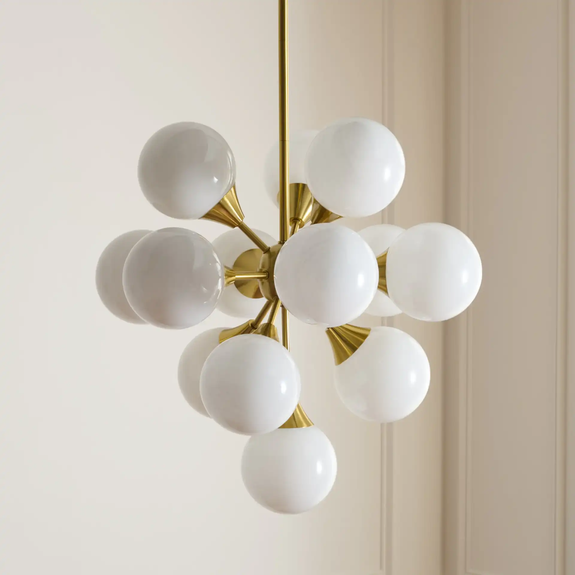 Delvine Thirteen-Light Chandelier in Brass / White in a styled room