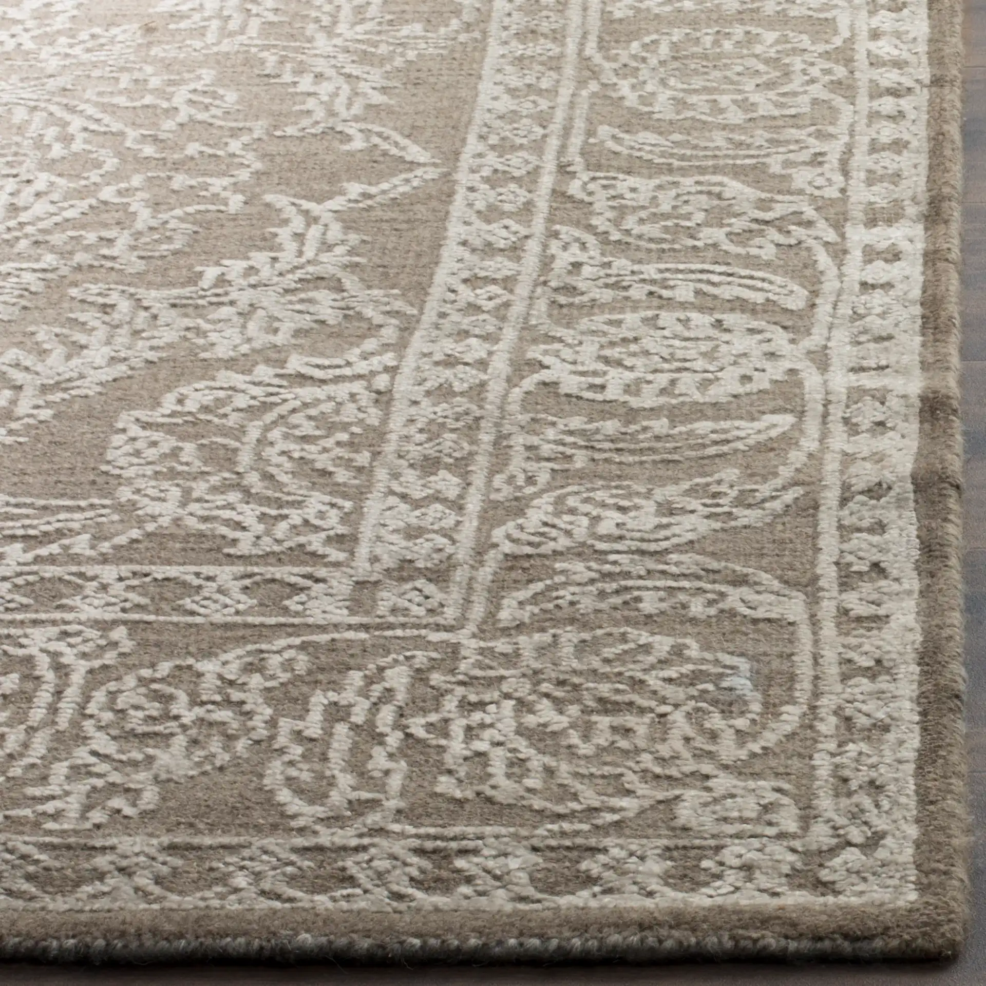 Chester Floral Scroll Hand-Knotted Rug in Stone Gray / Pearl in a styled room