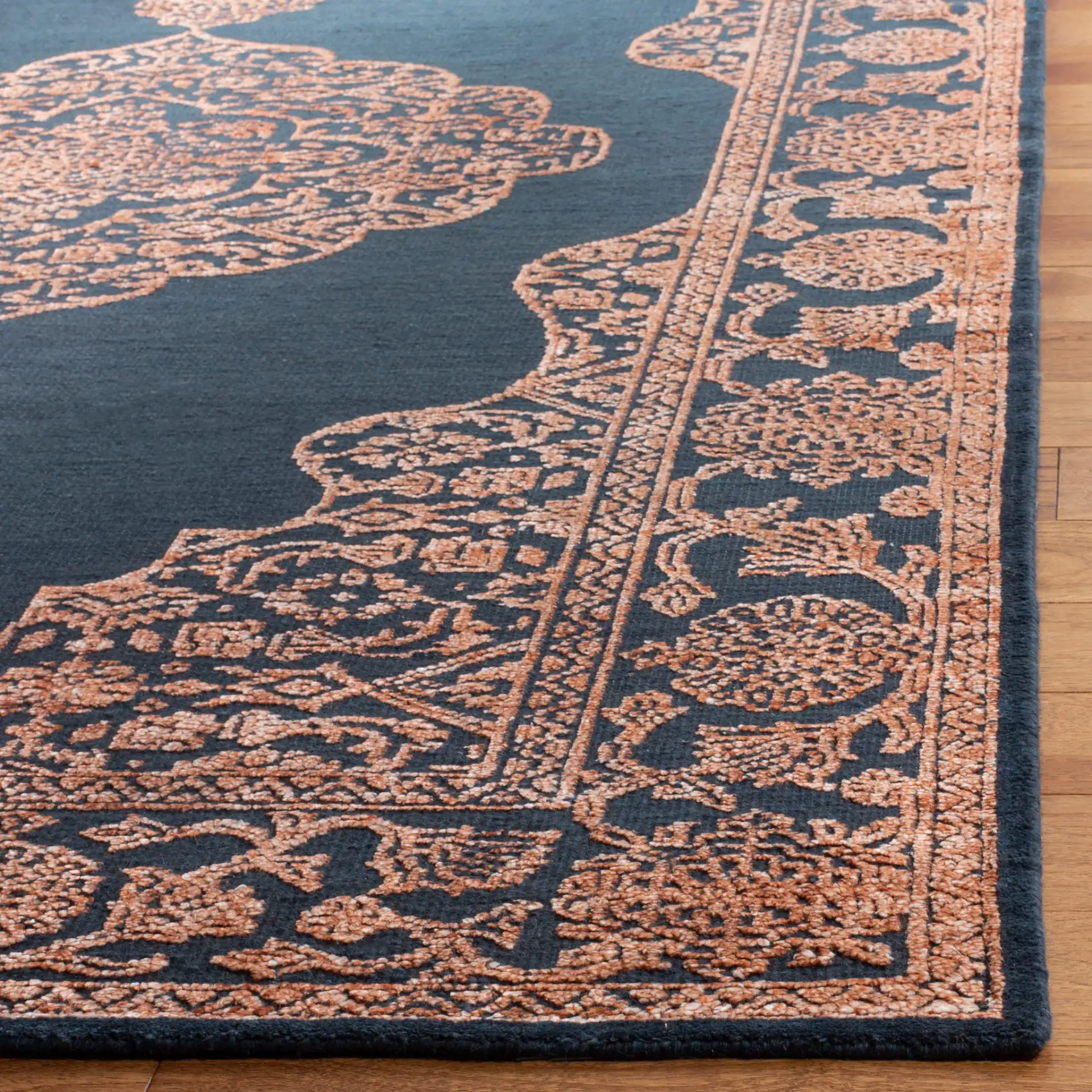 Chester Medallion Hand-Knotted Rug in Navy / Rust in a styled room