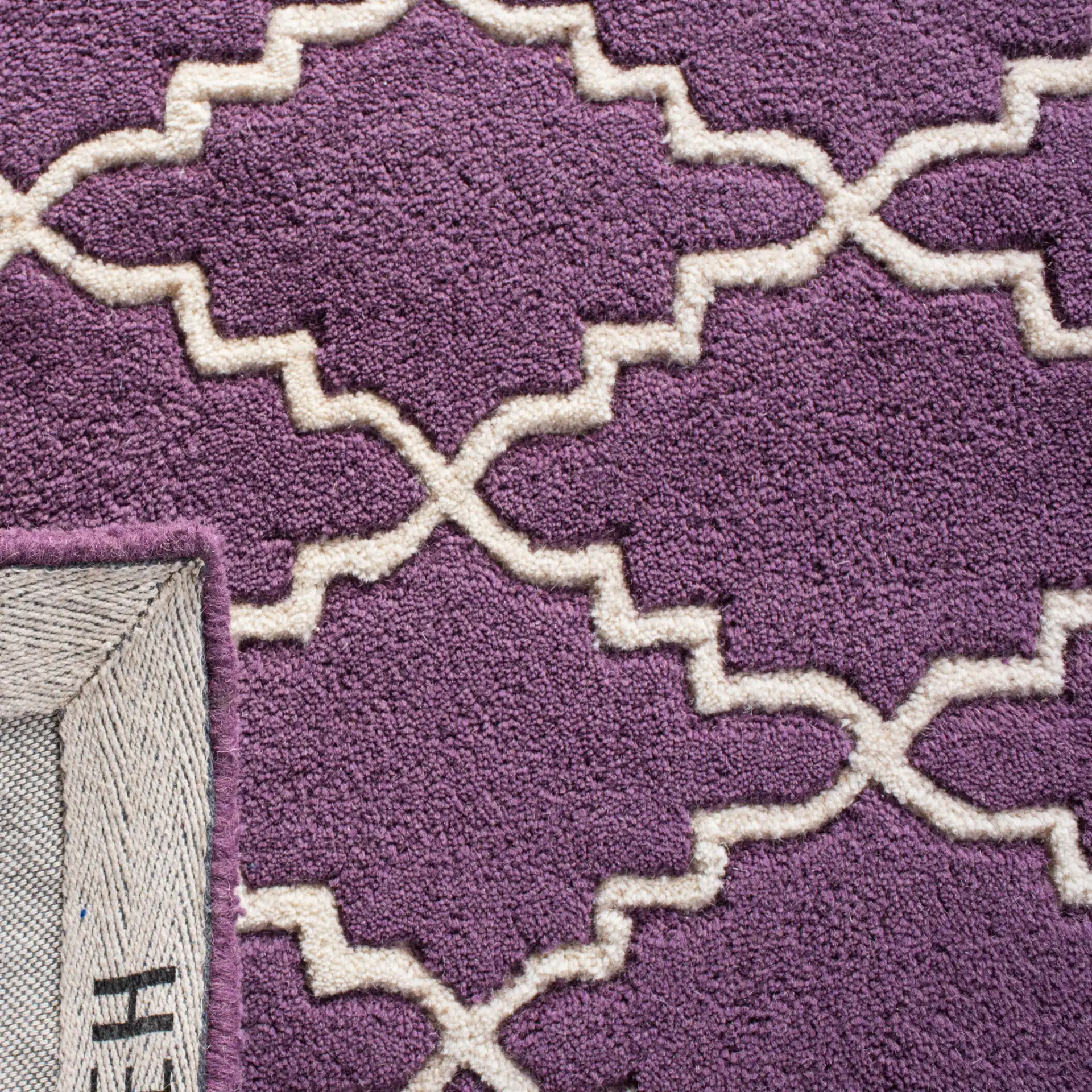 Chatham Stepped Trellis Hand-Tufted Wool Rug in Purple / Ivory in a styled room