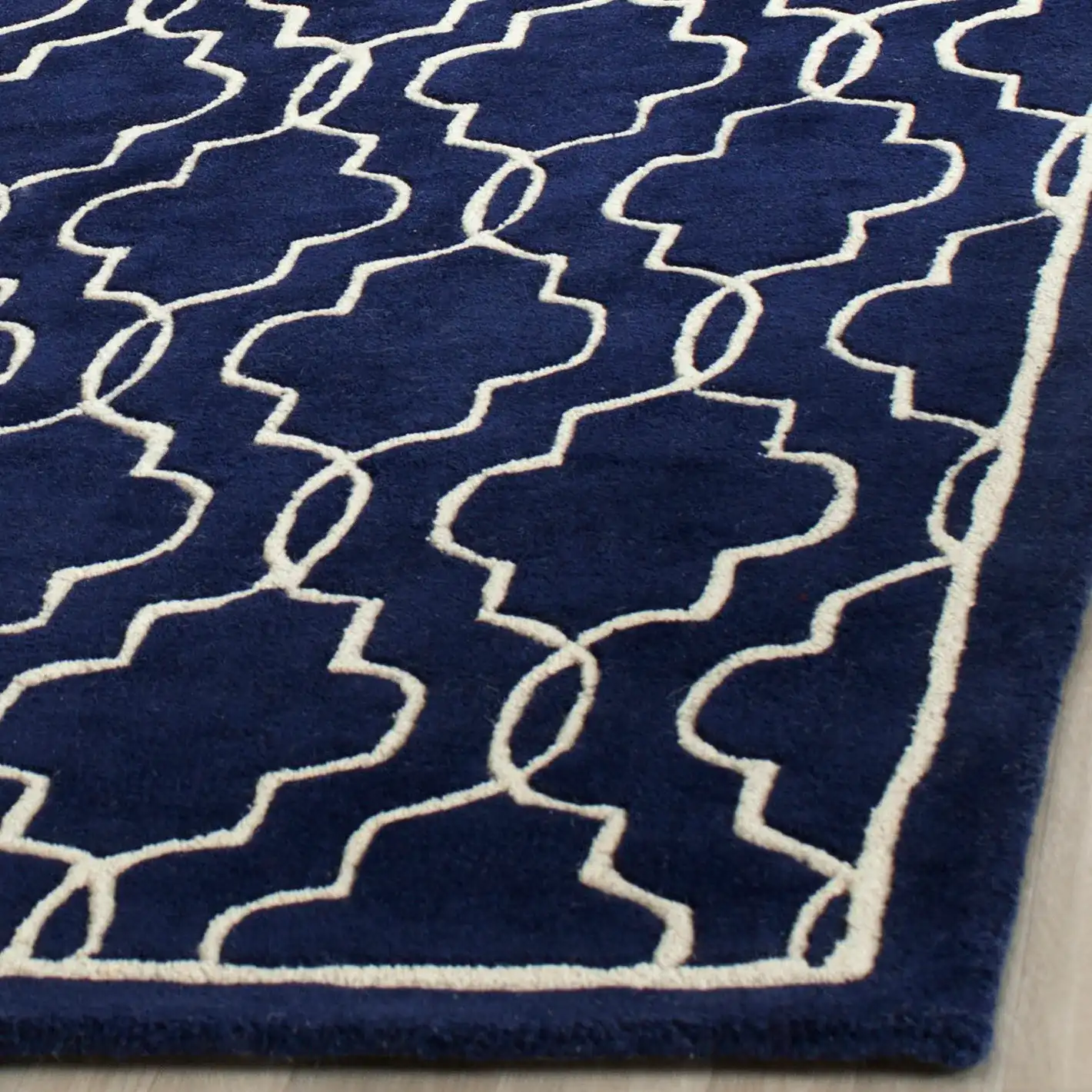 Chatham Chain Trellis Hand-Tufted Wool Rug in Dark Blue / Ivory in a styled room