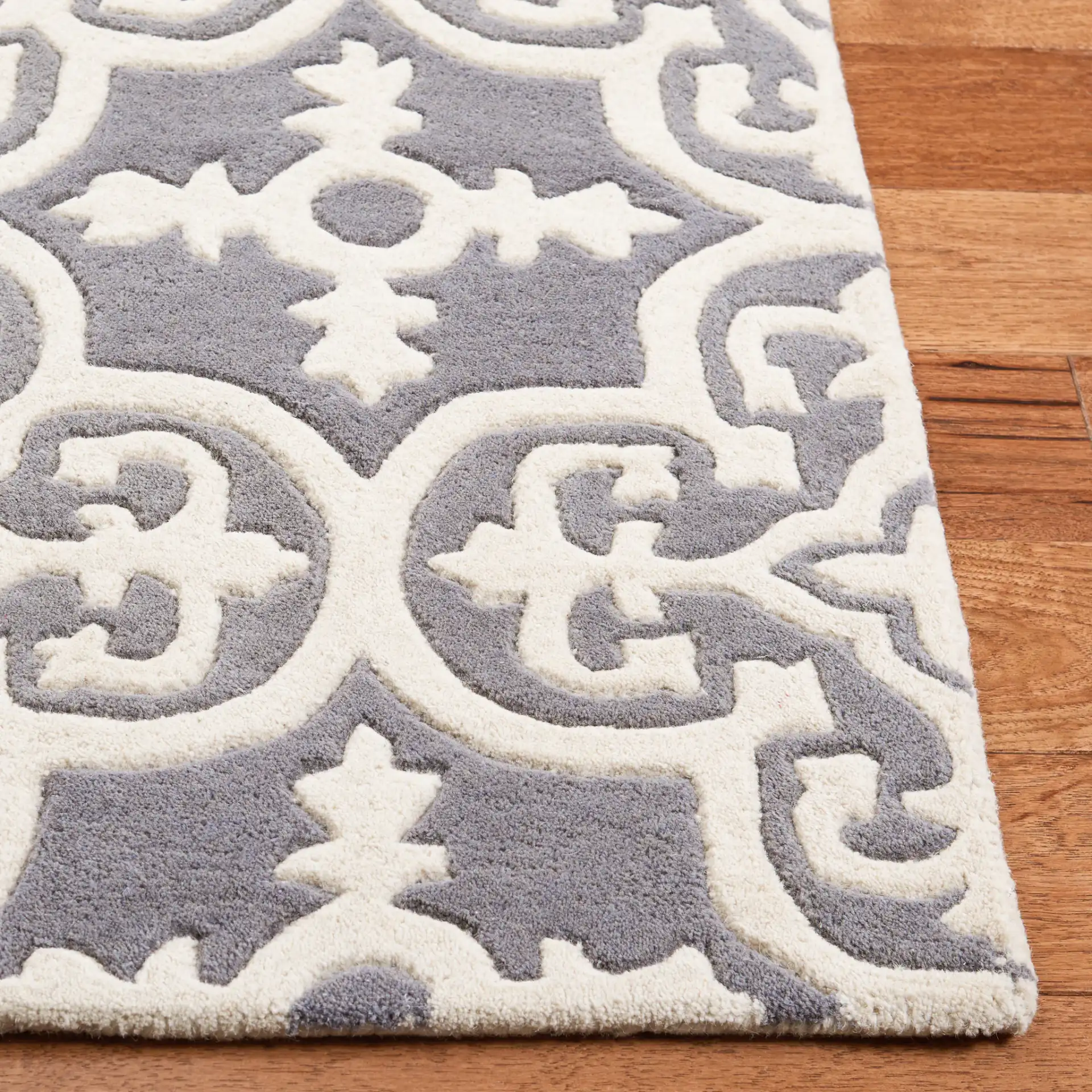 Chatham Tile Trellis Hand-Tufted Wool Rug in Dark Gray / Ivory in a styled room