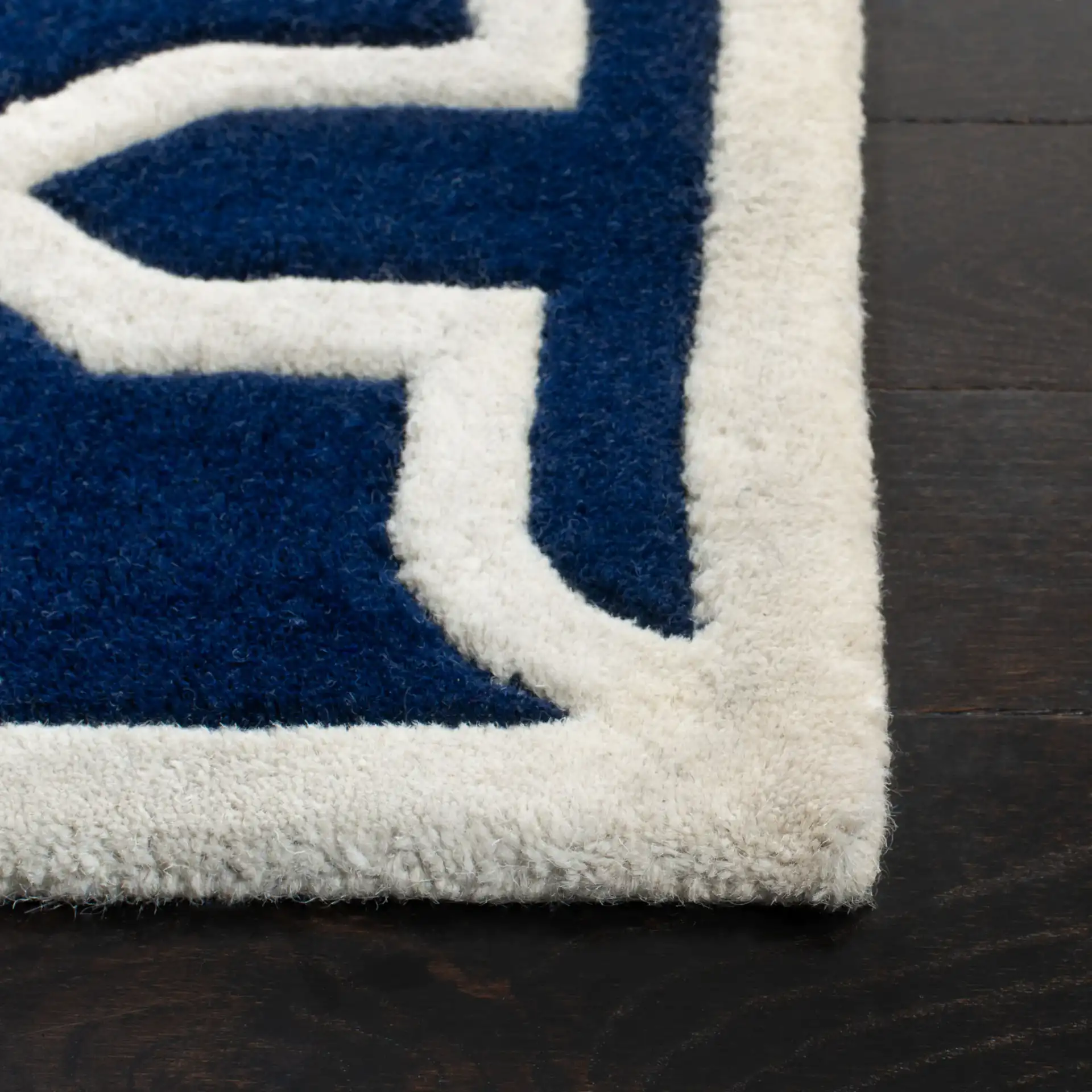 Chatham Star Lattice Hand-Tufted Wool Rug in Dark Blue / Ivory in a styled room