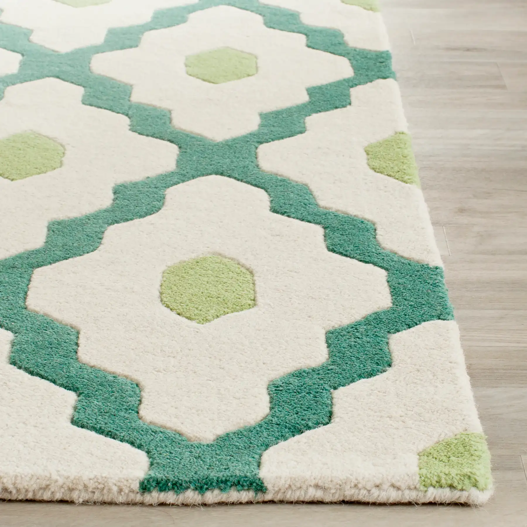 Chatham Ogee Hand-Tufted Wool Rug in Ivory / Teal in a styled room