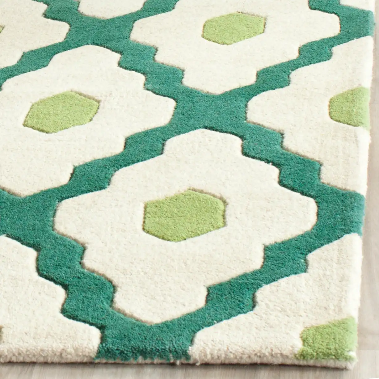 Chatham Ogee Hand-Tufted Wool Rug in Ivory / Teal in a styled room
