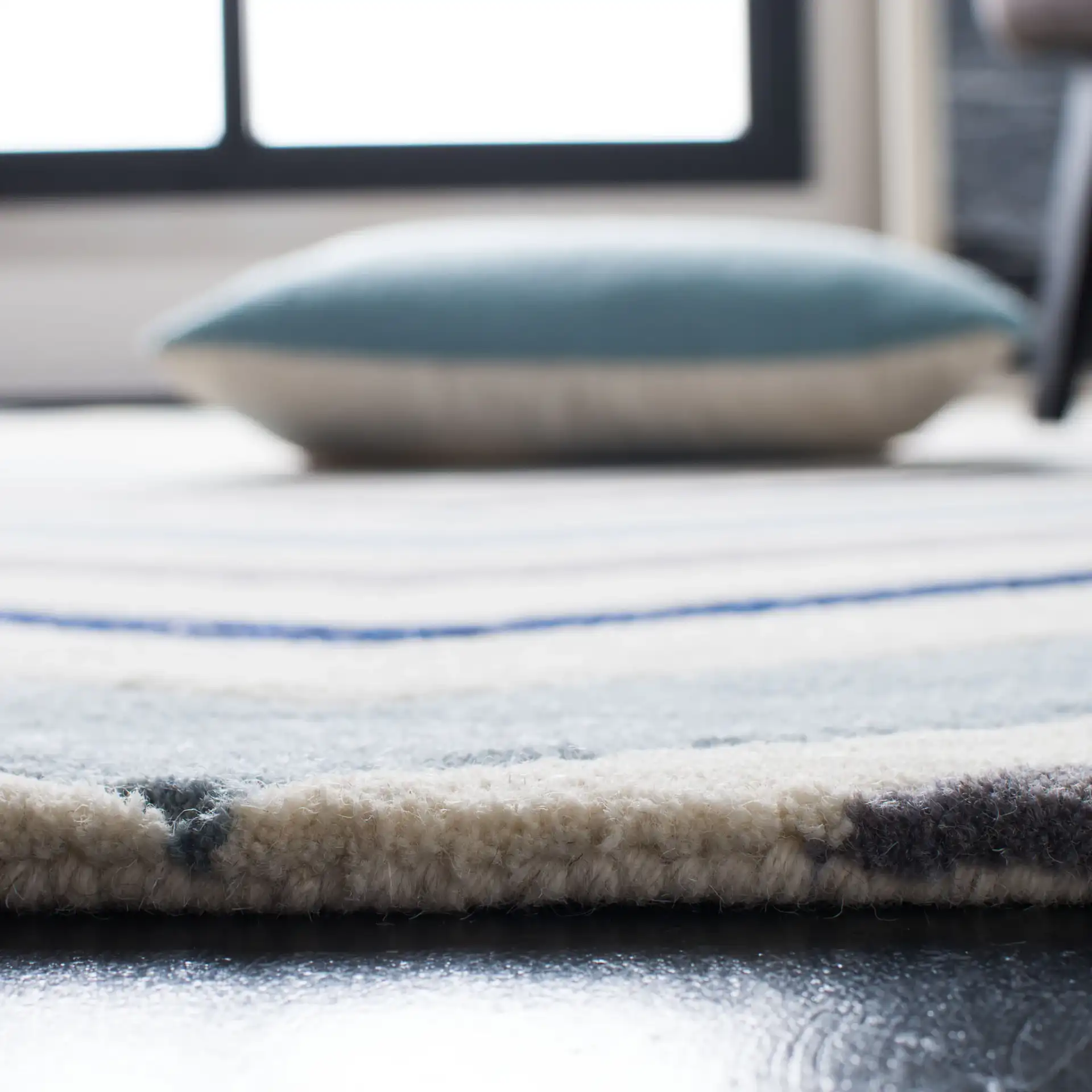 Chatham Wide Chevron Hand-Tufted Wool Rug in Ivory / Dark Gray in a styled room