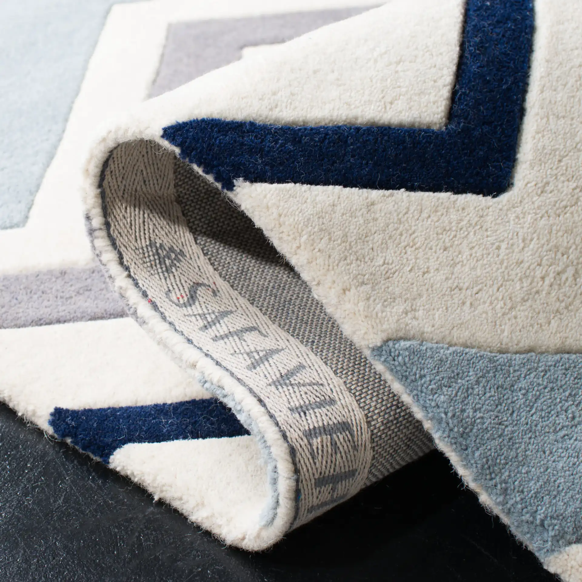 Chatham Wide Chevron Hand-Tufted Wool Rug in Ivory / Dark Gray in a styled room