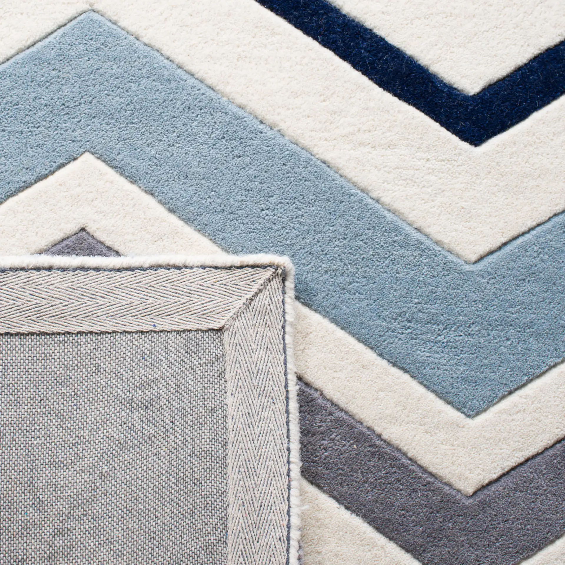 Chatham Wide Chevron Hand-Tufted Wool Rug in Ivory / Dark Gray in a styled room