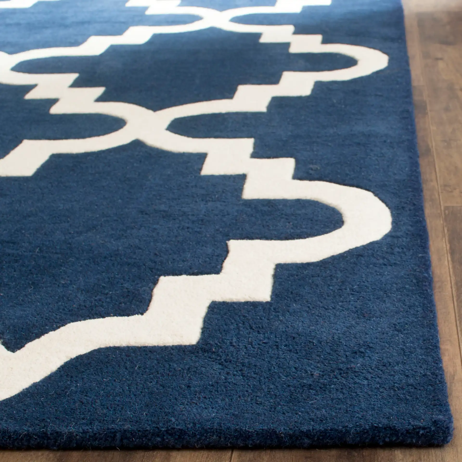 Chatham Large Stepped Trellis Hand-Tufted Wool Rug in Dark Blue / Ivory in a styled room