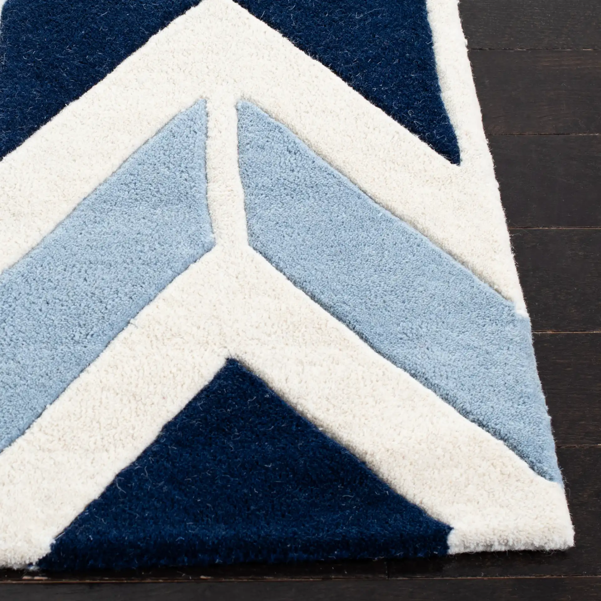 Chatham Arrow Chevron Hand-Tufted Wool Rug in Dark Blue / Light Blue in a styled room