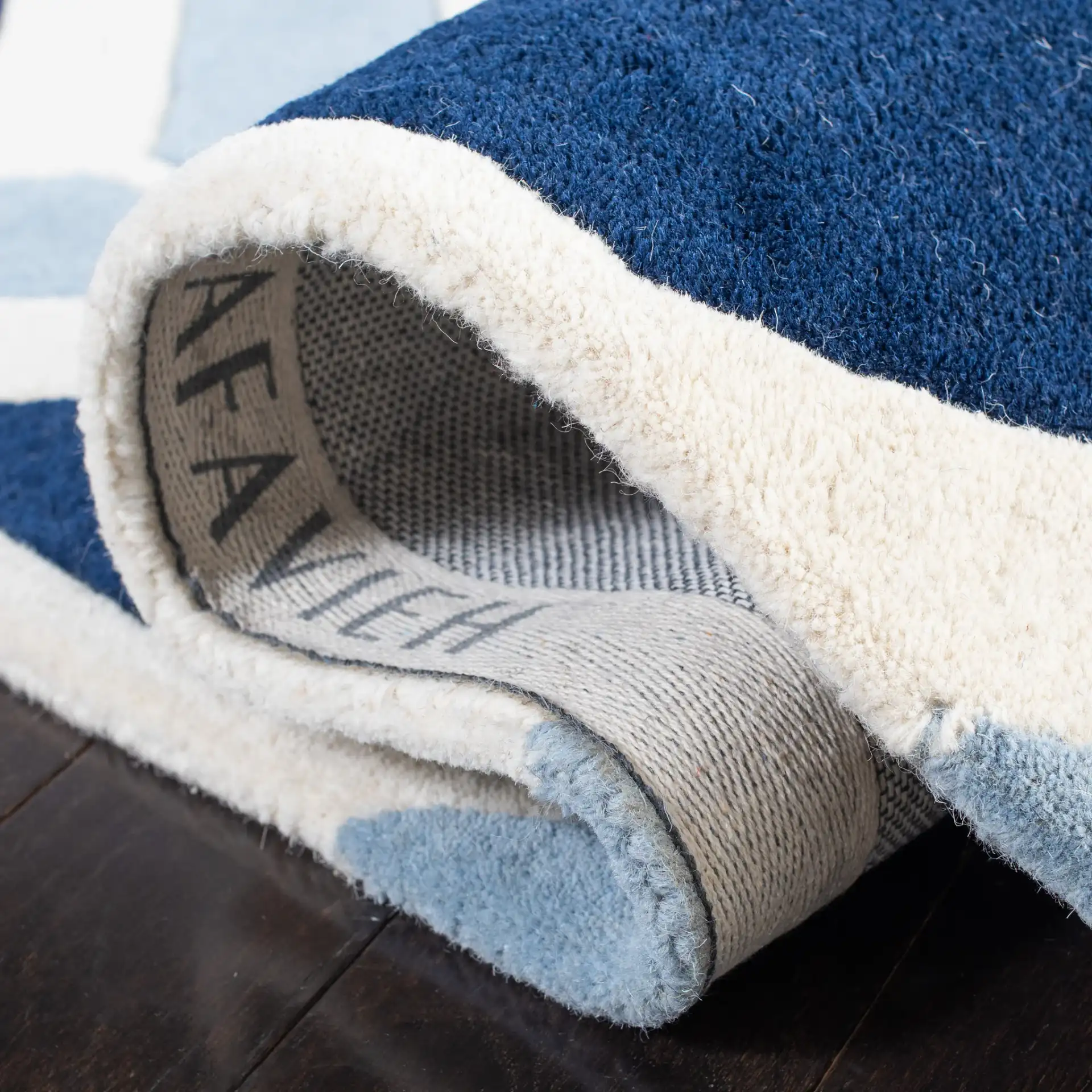 Chatham Arrow Chevron Hand-Tufted Wool Rug in Dark Blue / Light Blue in a styled room