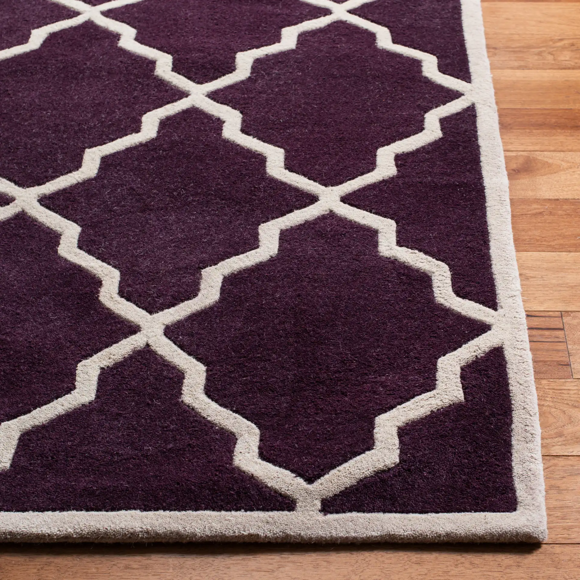 Chatham Stepped Diamond Trellis Hand-Tufted Wool Rug in Dark Purple in a styled room