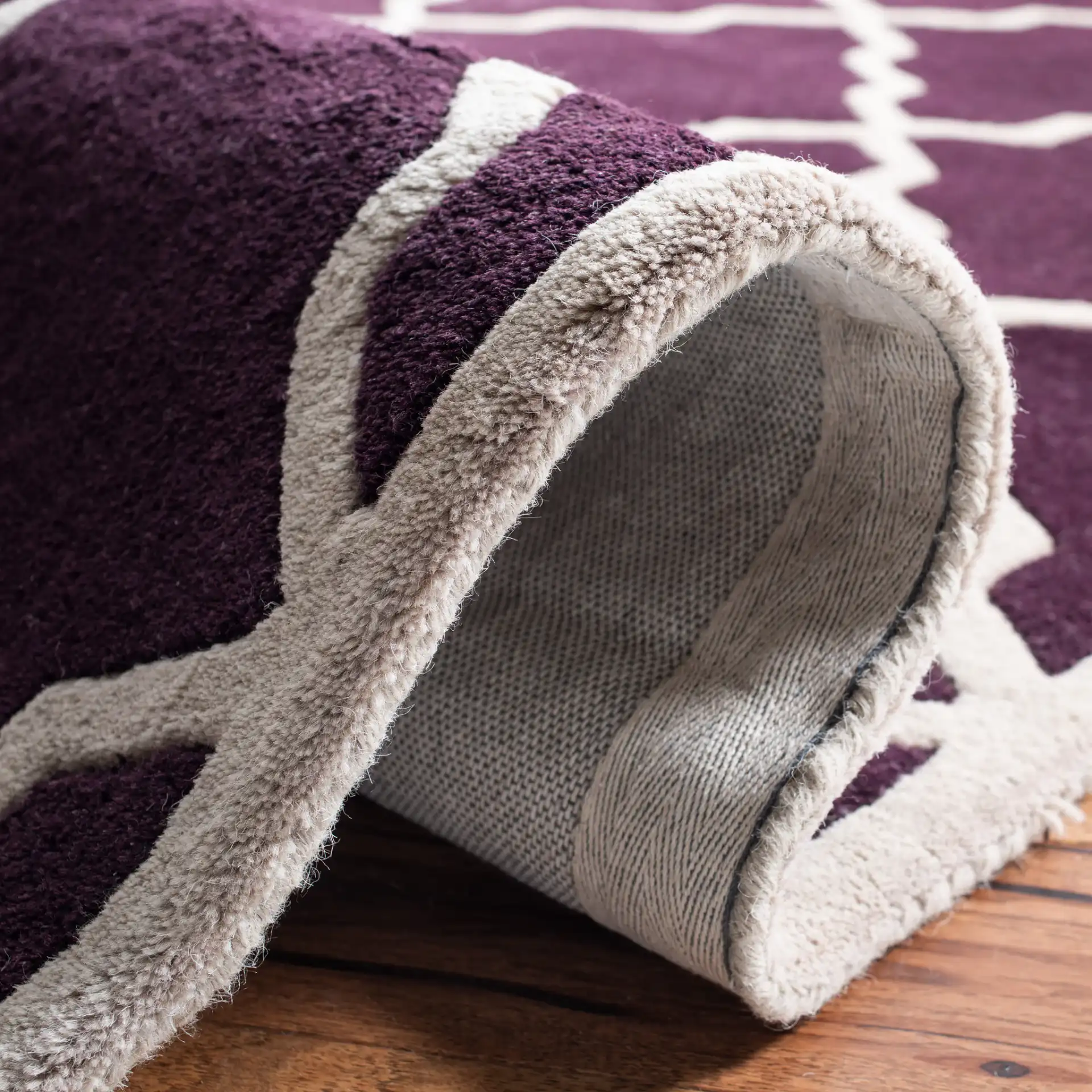 Chatham Stepped Diamond Trellis Hand-Tufted Wool Rug in Dark Purple in a styled room