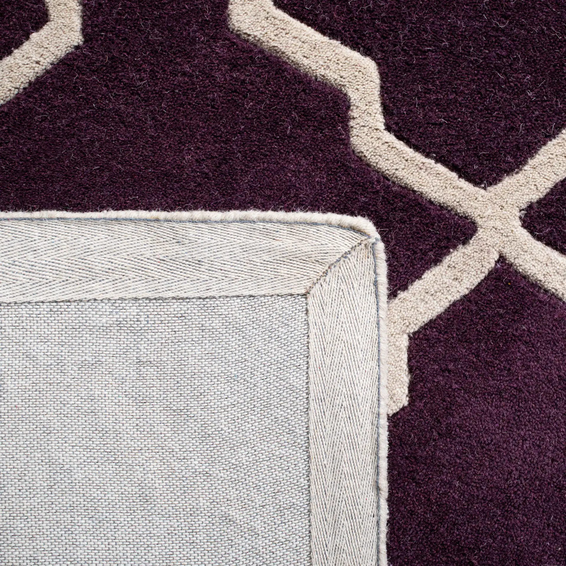 Chatham Stepped Diamond Trellis Hand-Tufted Wool Rug in Dark Purple in a styled room