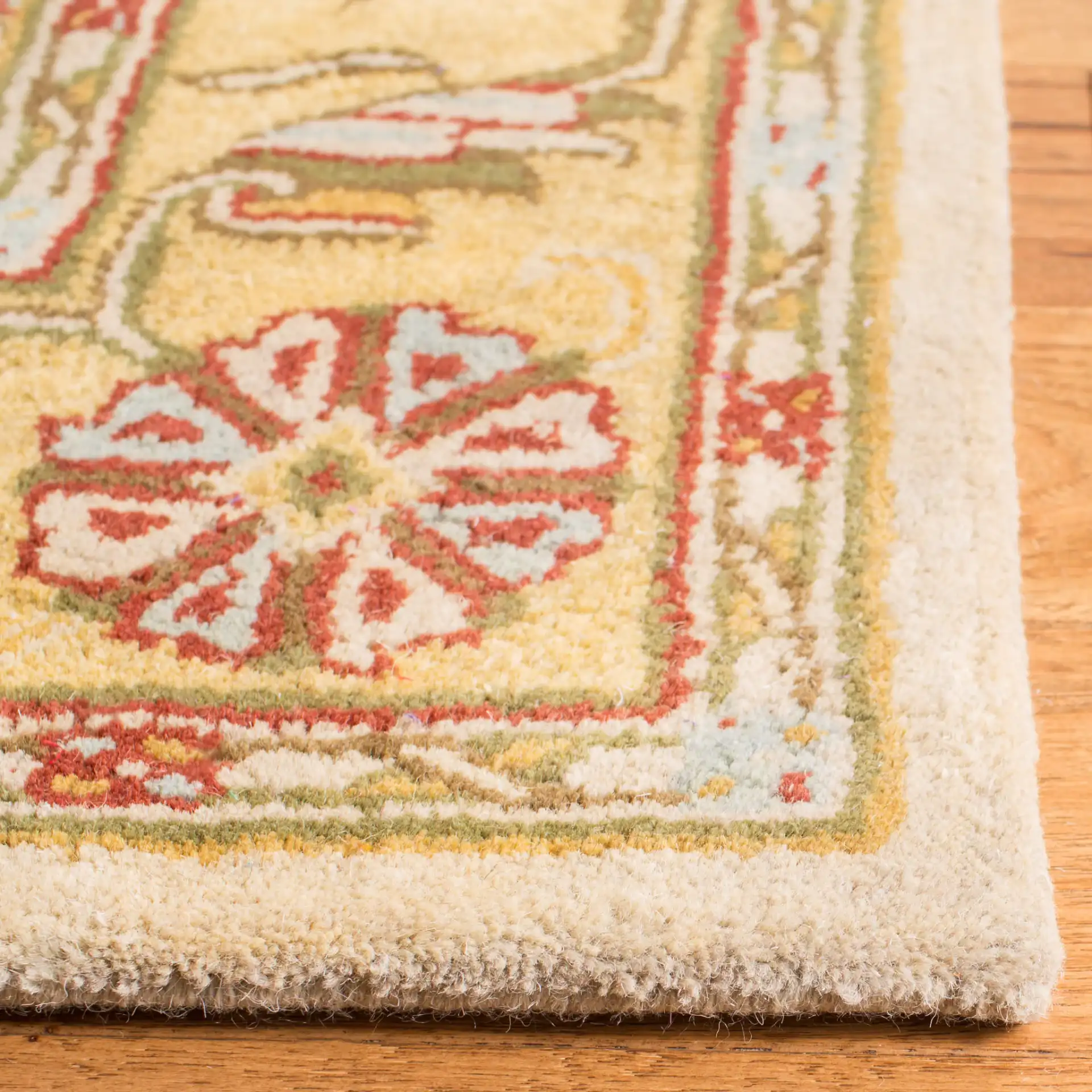Classic Traditional Scroll Bordered Hand-Tufted Wool Rug in Gray / Light Gold in a styled room