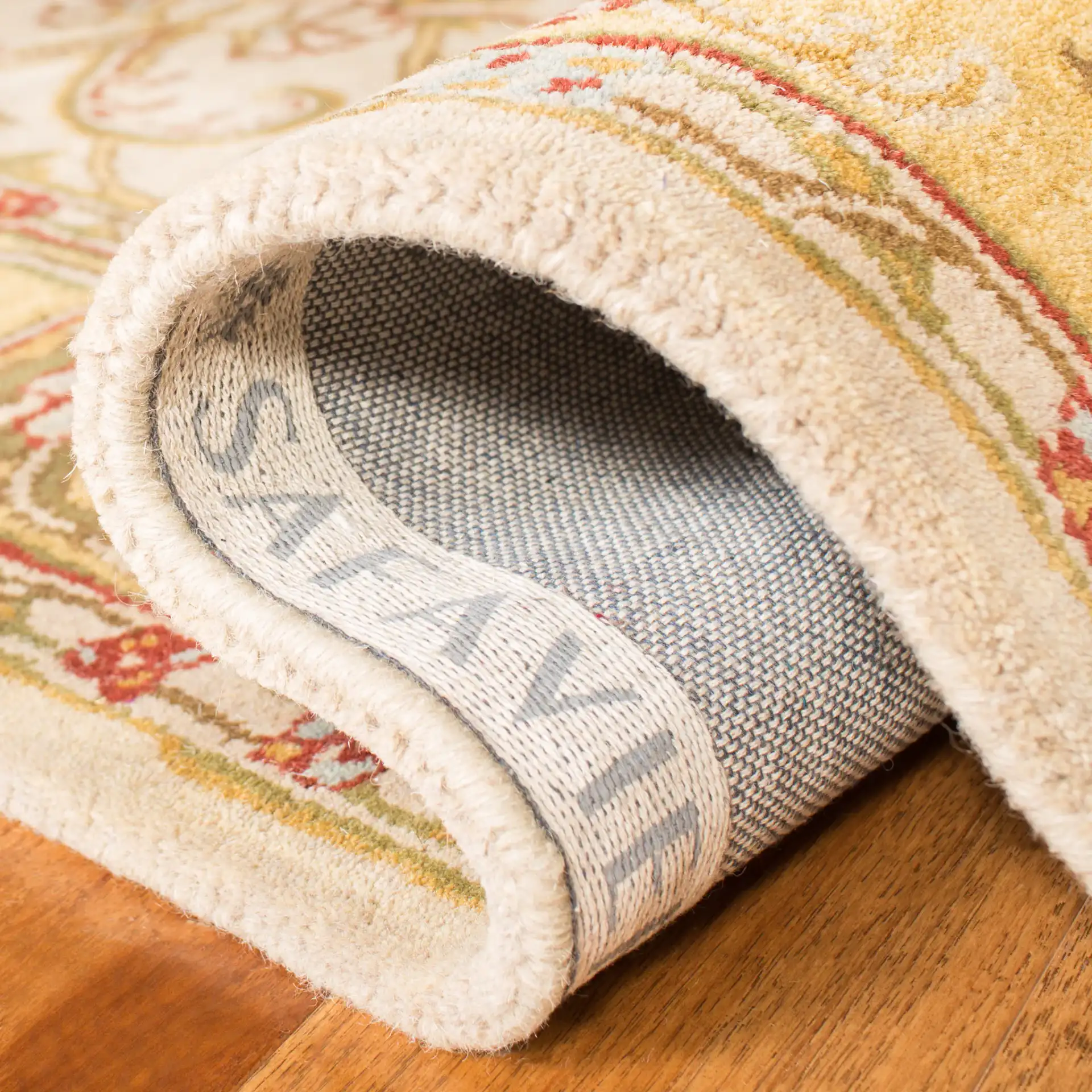 Classic Traditional Scroll Bordered Hand-Tufted Wool Rug in Gray / Light Gold in a styled room