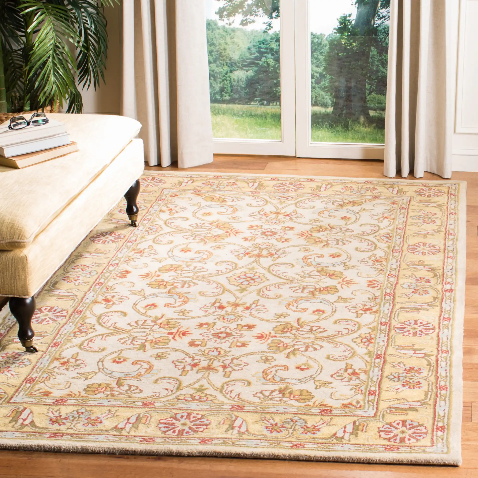 Classic Traditional Scroll Bordered Hand-Tufted Wool Rug in Gray / Light Gold in a styled room