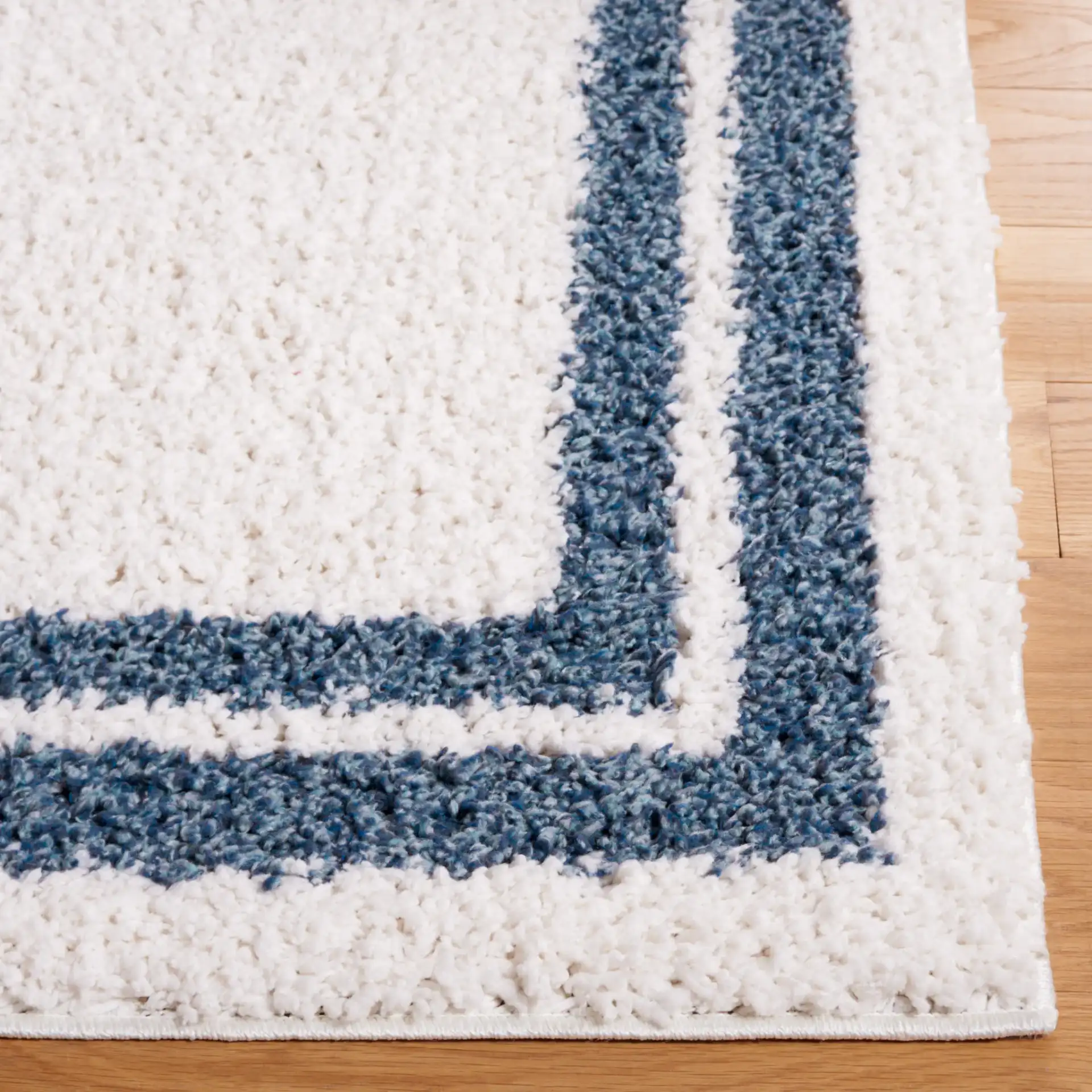 Calico Double Border Shag Rug in Ivory / Blue in a styled room