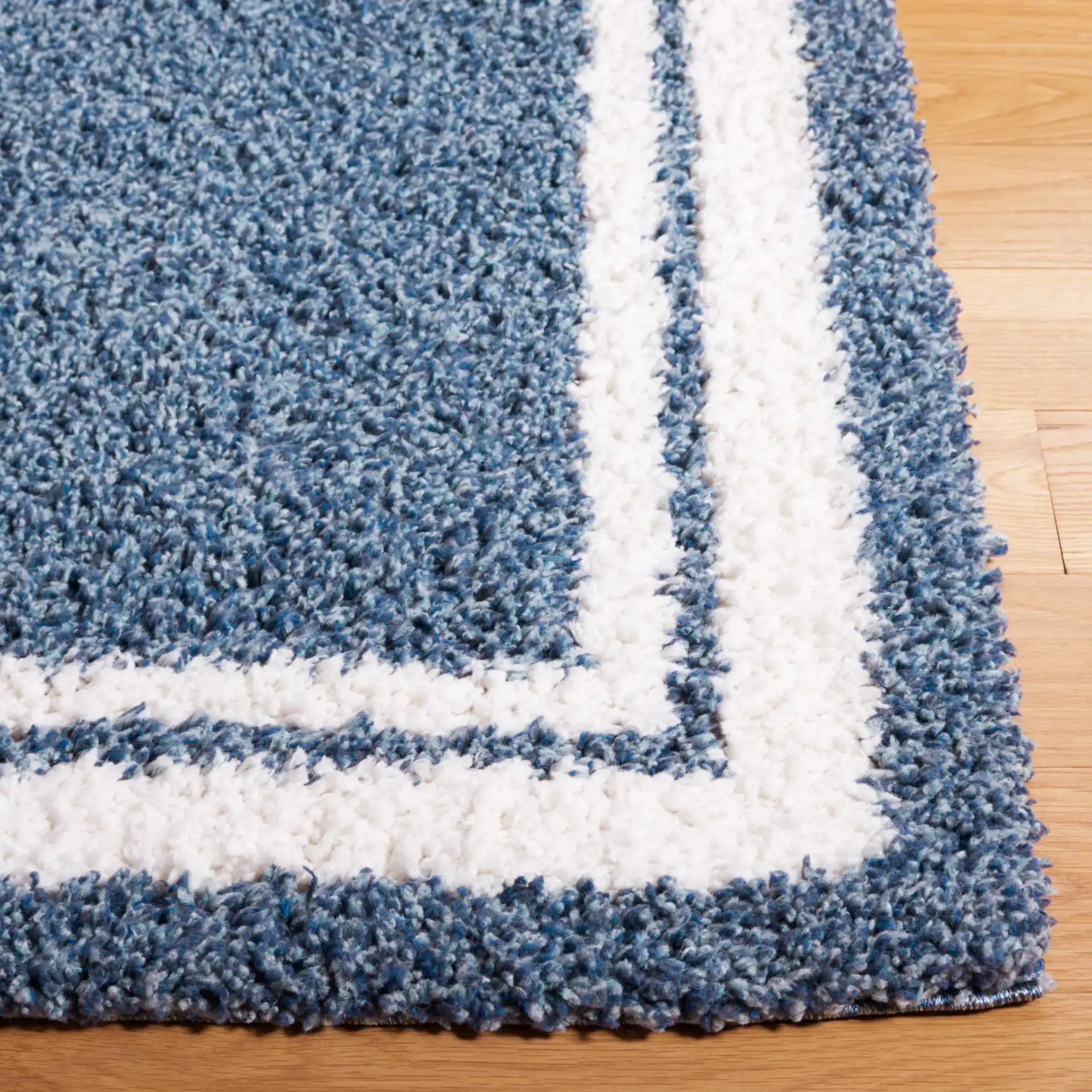 Calico Double Border Shag Rug in Blue / Ivory in a styled room