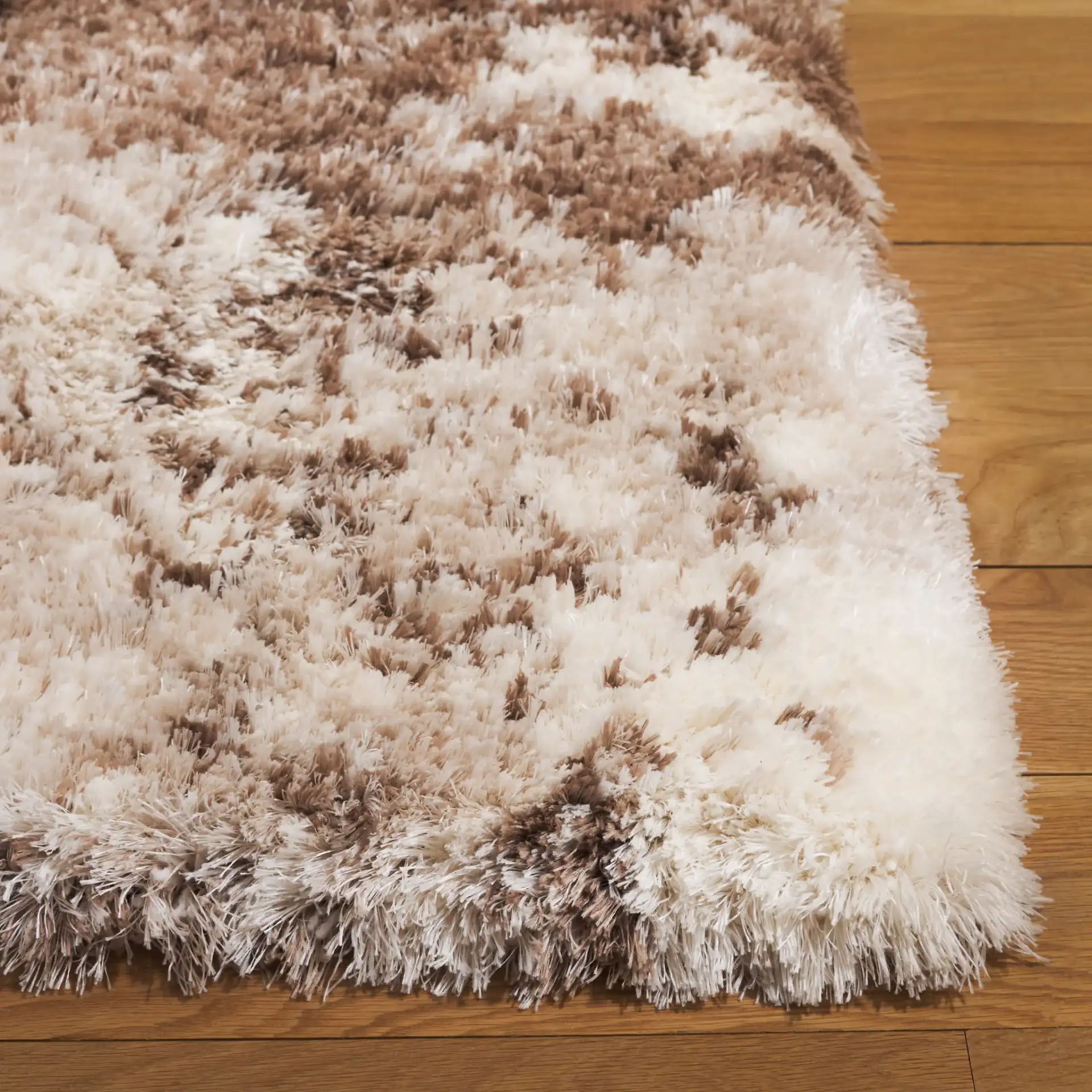 Cloud Abstract Splatter Shag Rug in Ivory / Brown in a styled room
