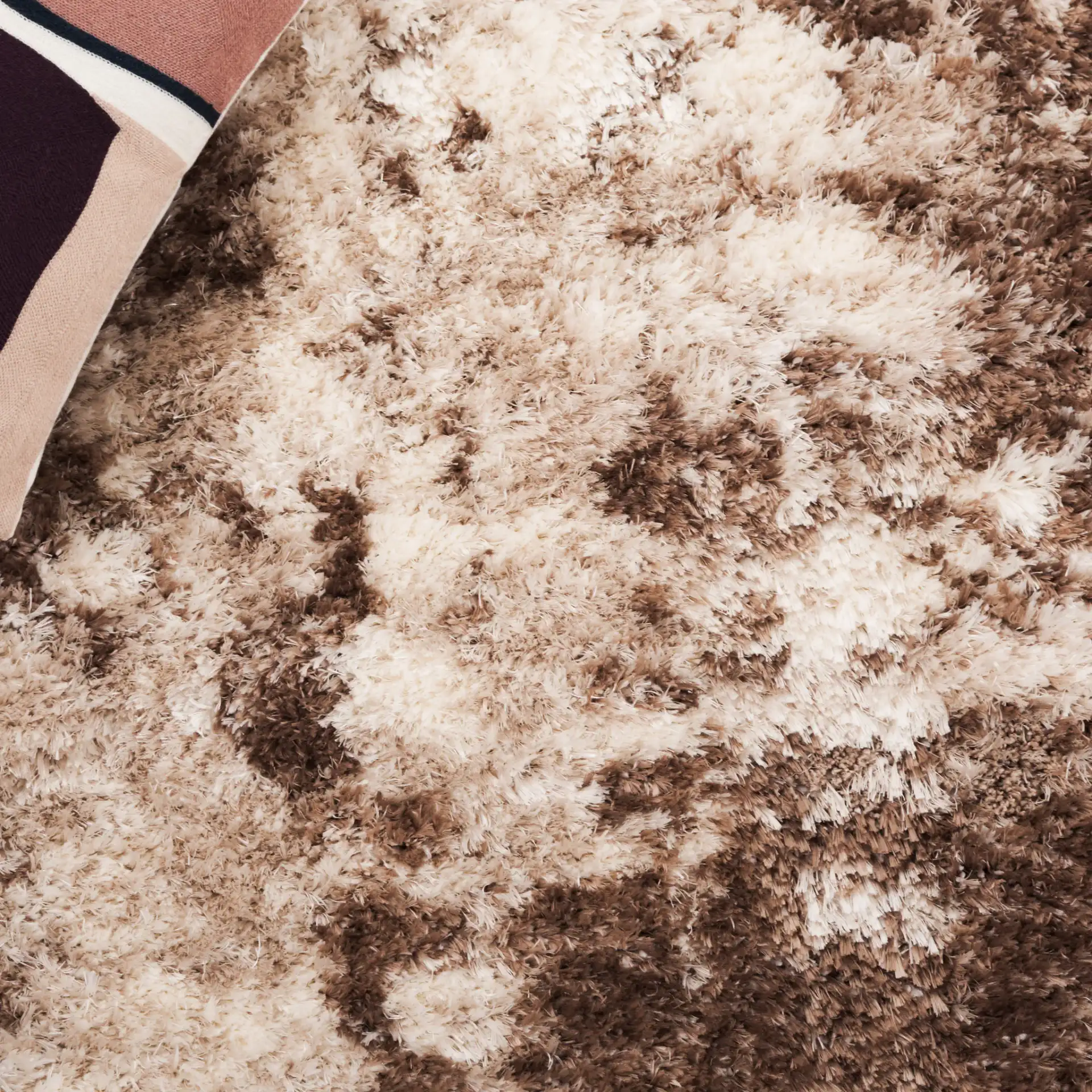 Cloud Abstract Splatter Shag Rug in Ivory / Brown in a styled room