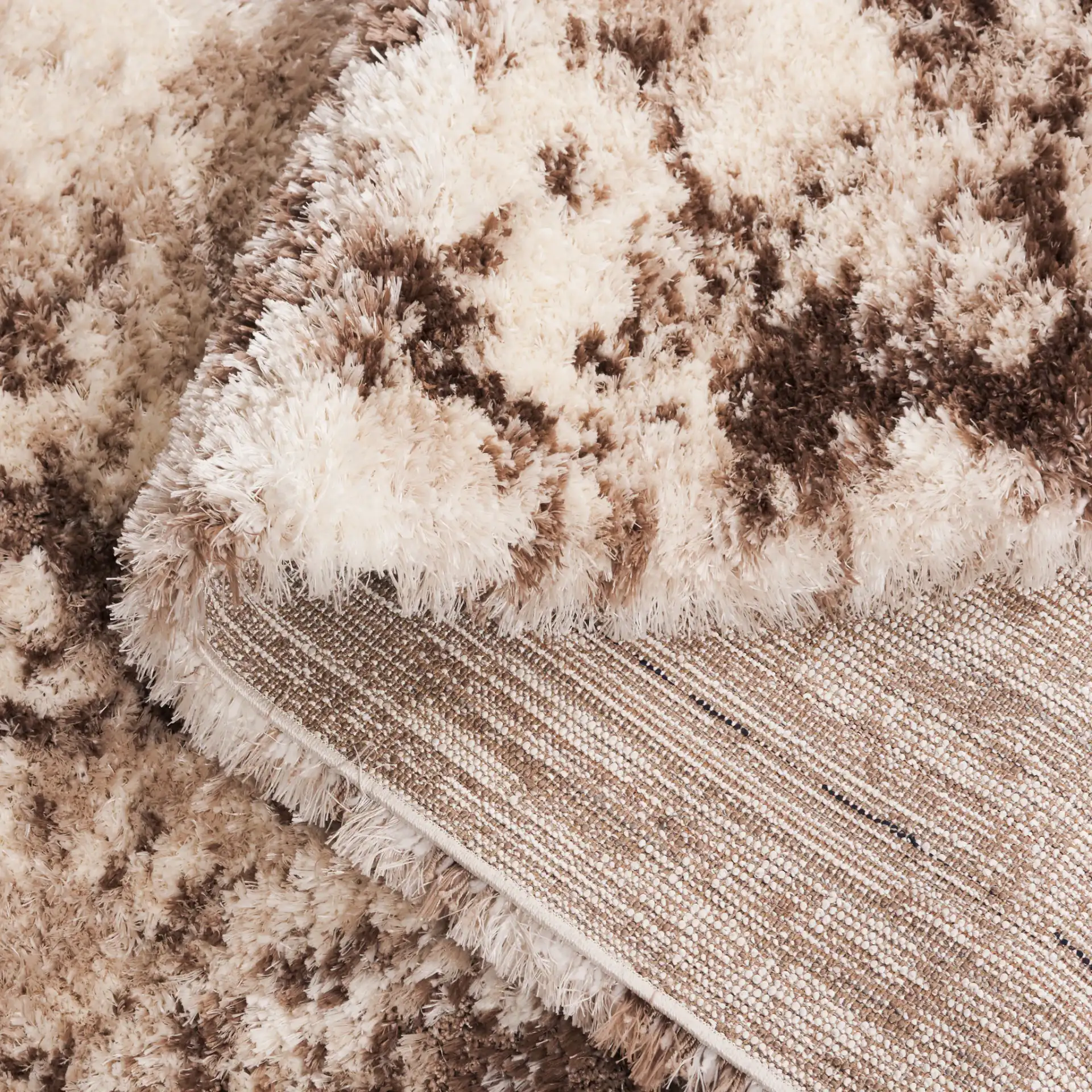 Cloud Abstract Splatter Shag Rug in Ivory / Brown in a styled room
