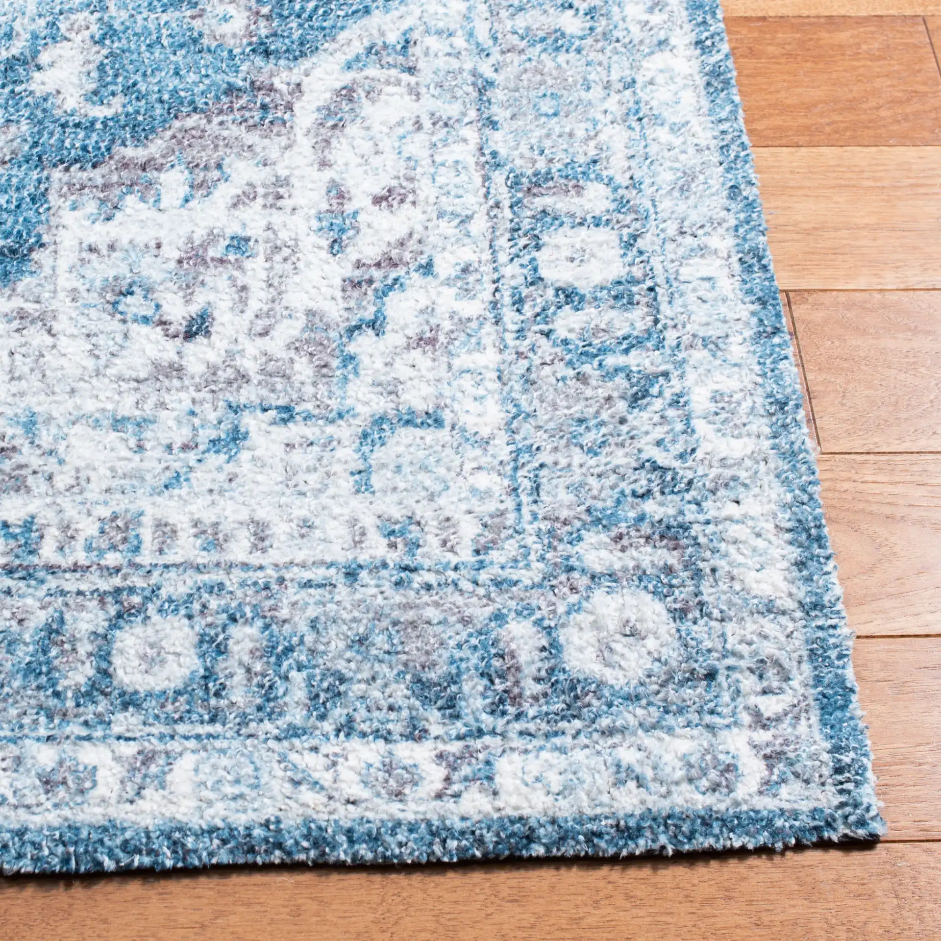 Classic Vintage Traditional Medallion Hand-Tufted Rug in Blue / Gray in a styled room