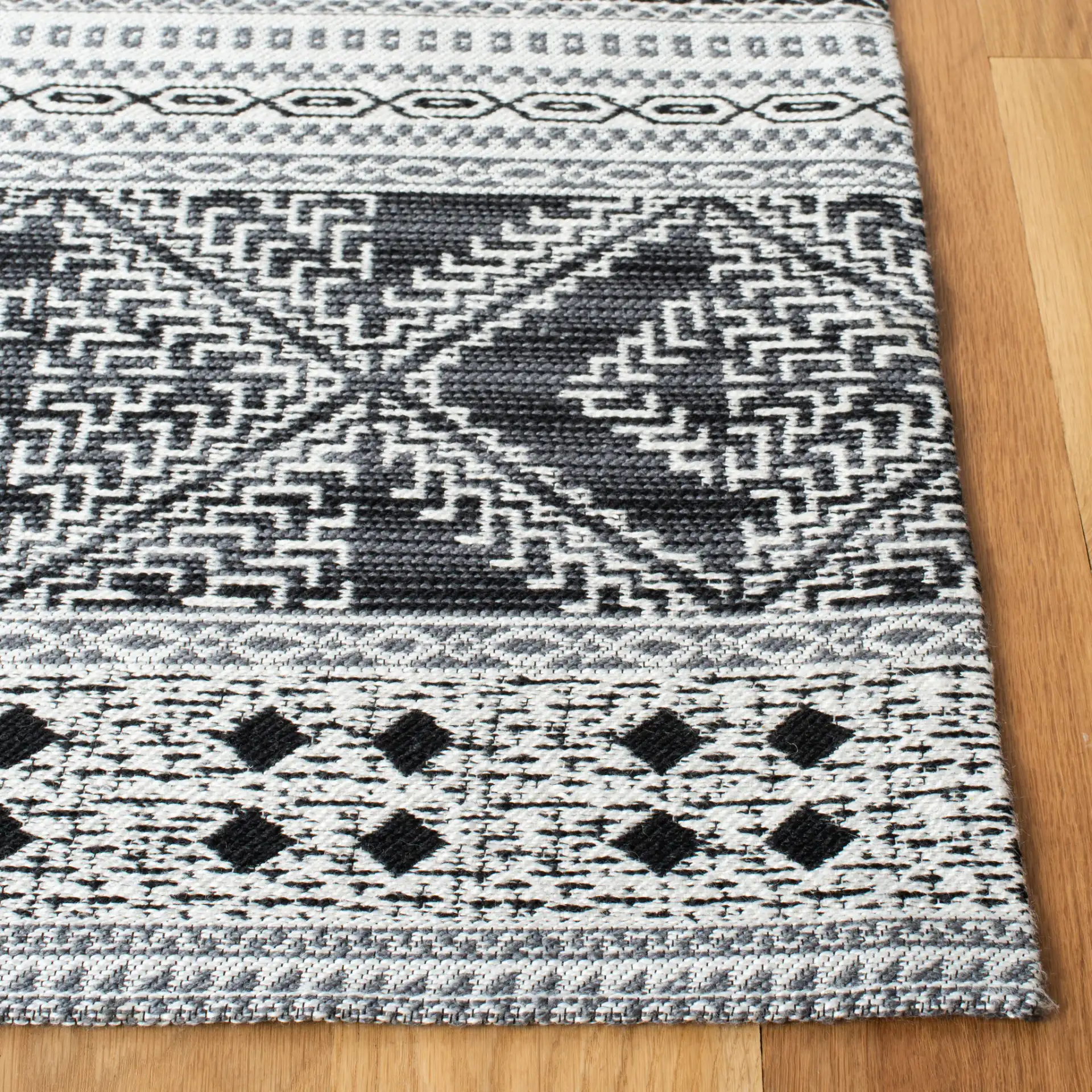 Classic Vintage Bohemian Geometric Hand-Woven Rug in Black in a styled room