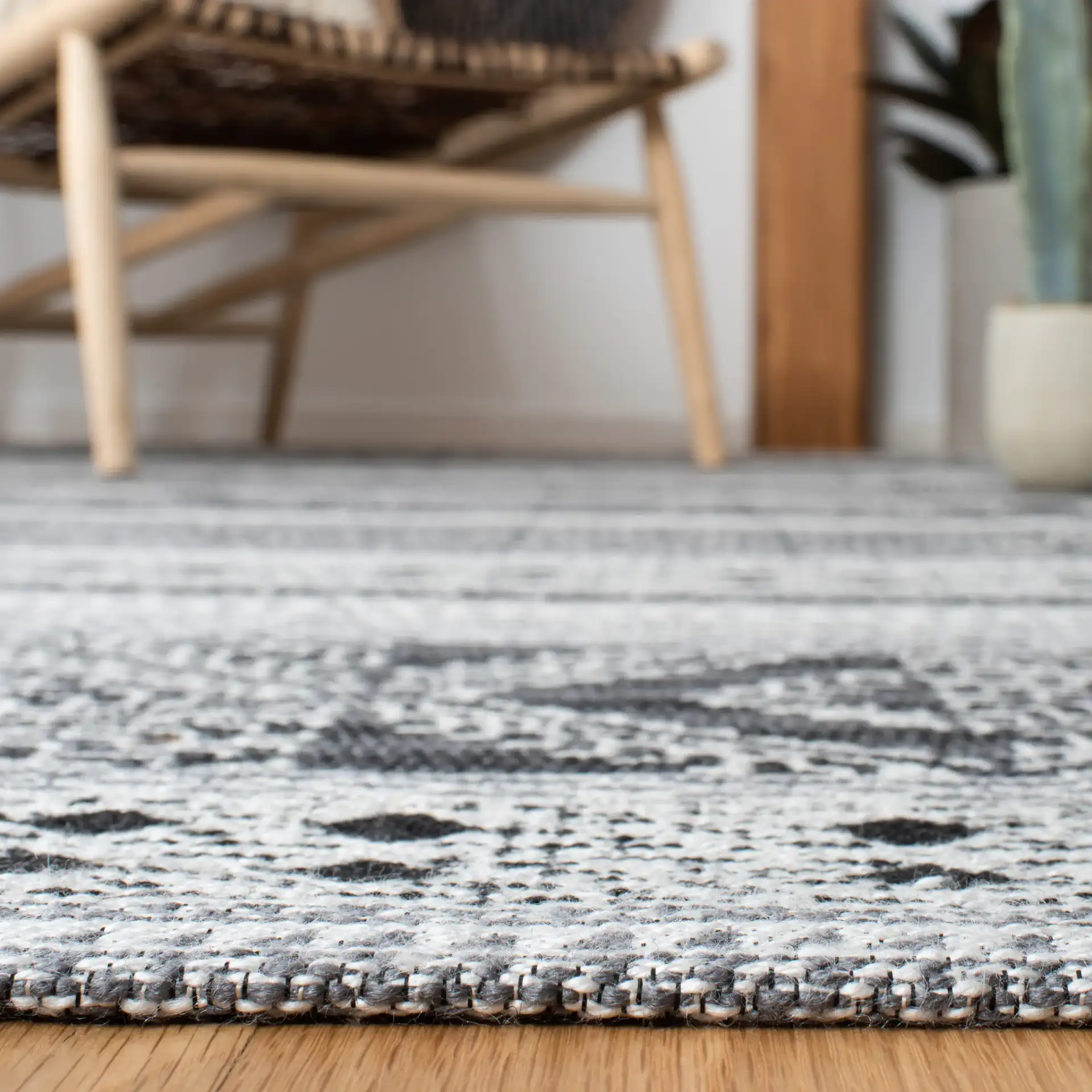 Classic Vintage Bohemian Geometric Hand-Woven Rug in Black in a styled room