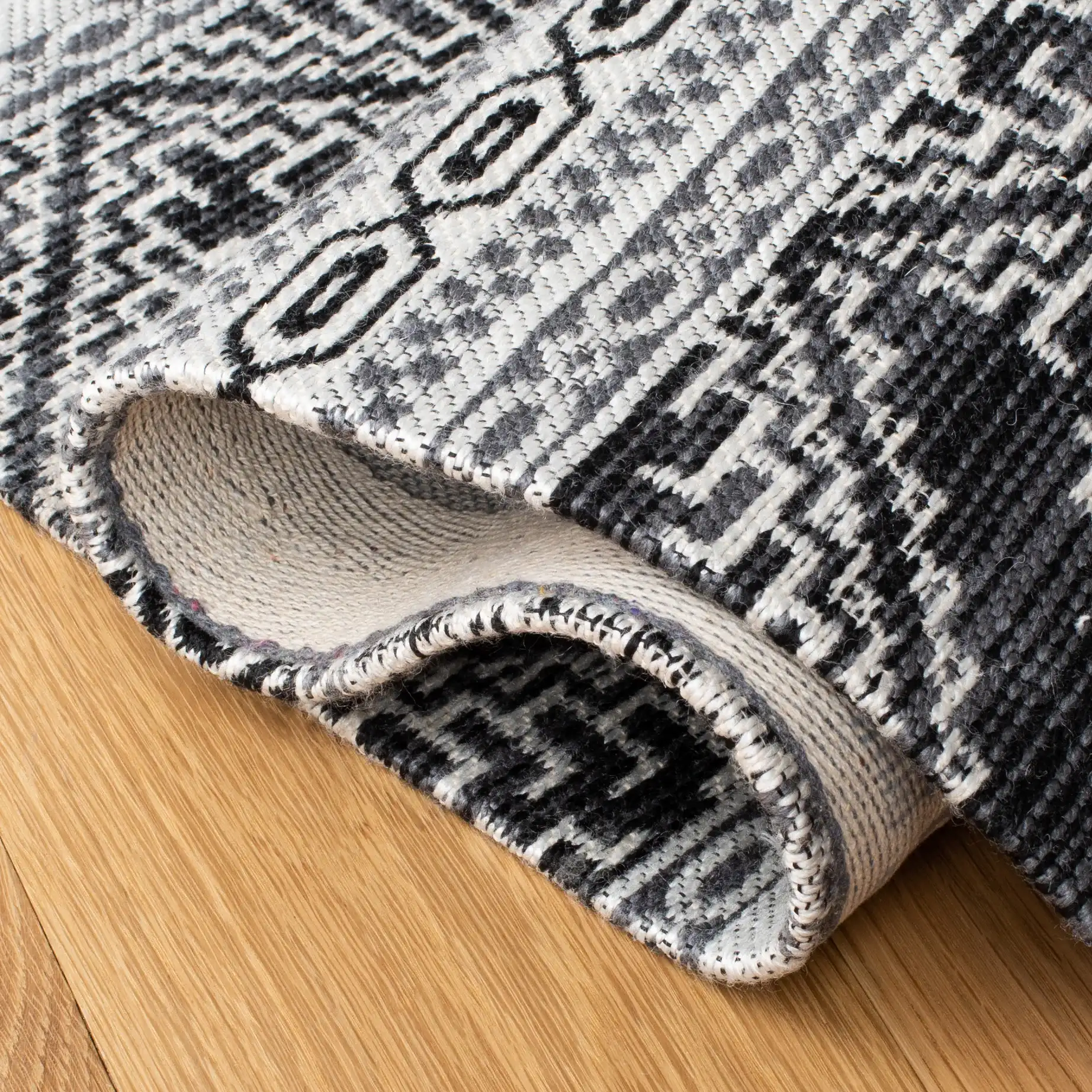Classic Vintage Bohemian Geometric Hand-Woven Rug in Black in a styled room