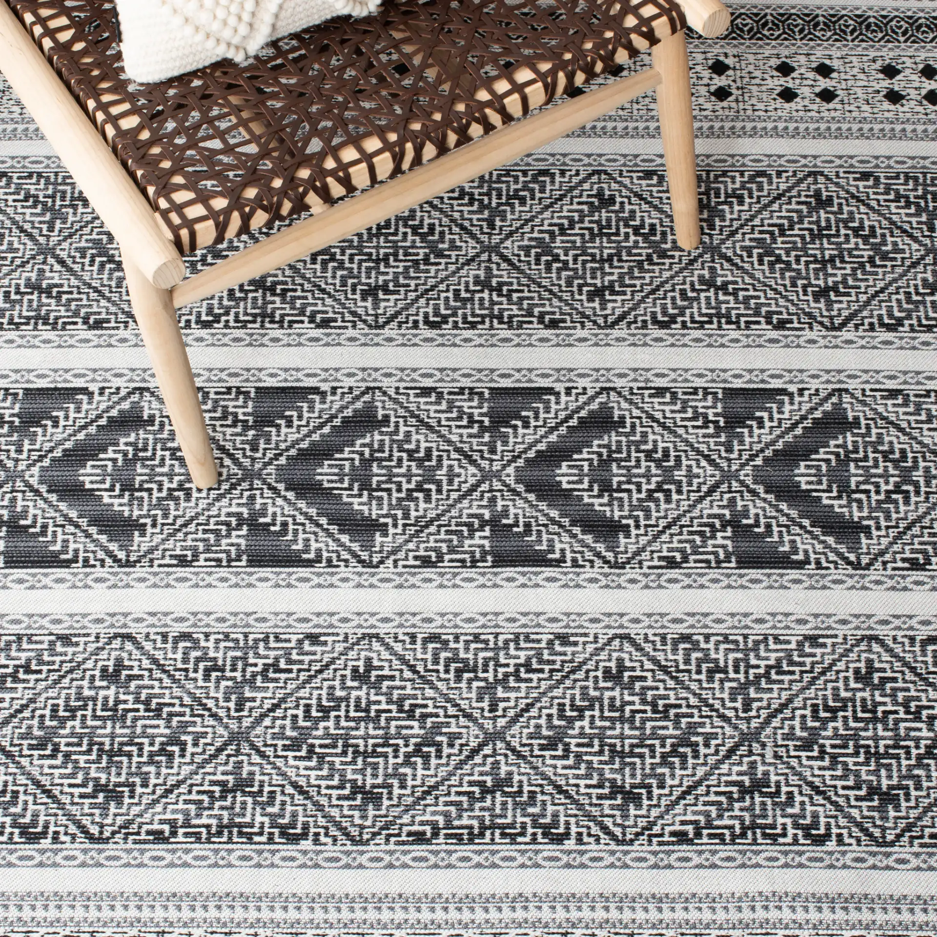 Classic Vintage Bohemian Geometric Hand-Woven Rug in Black in a styled room