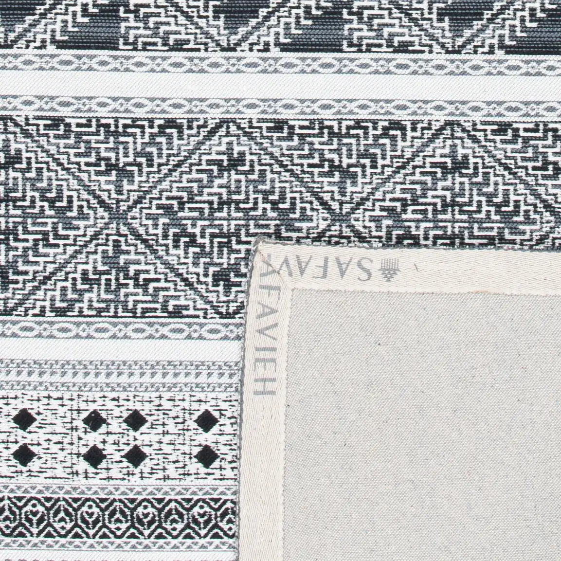 Classic Vintage Bohemian Geometric Hand-Woven Rug in Black in a styled room