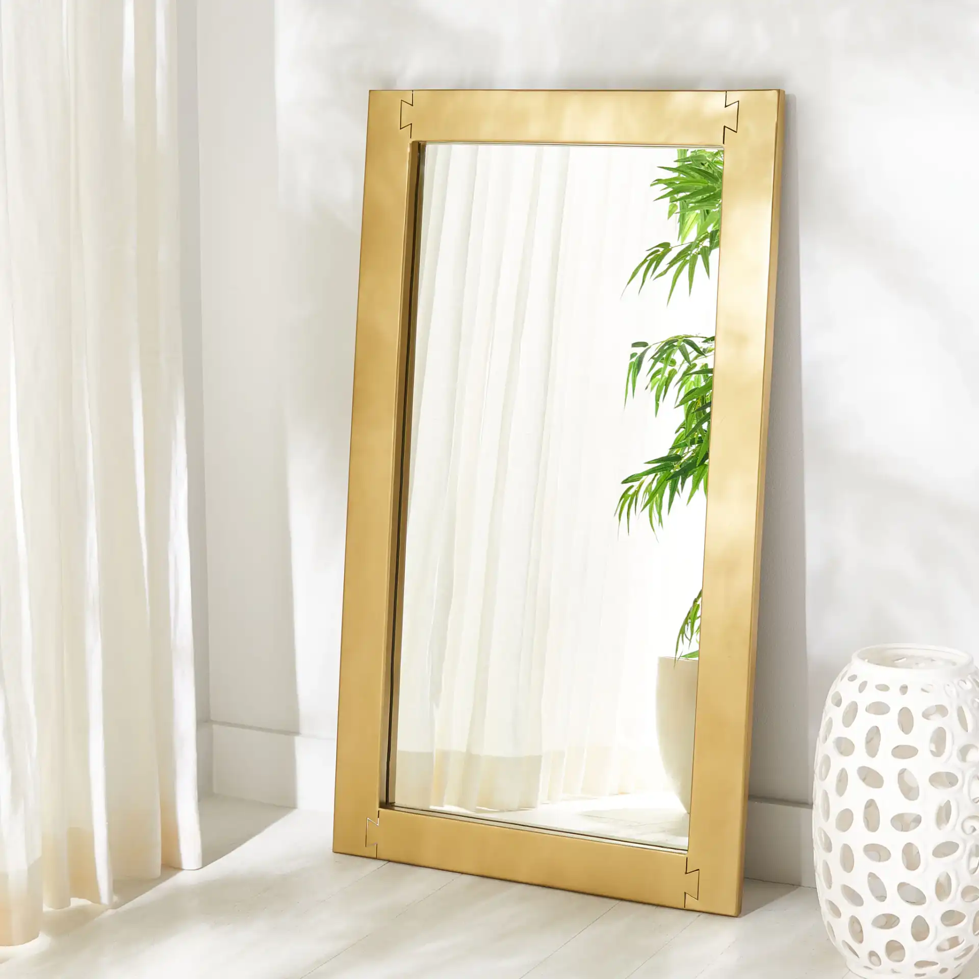 Ayden Rectangle Mirror in Brass in a styled room