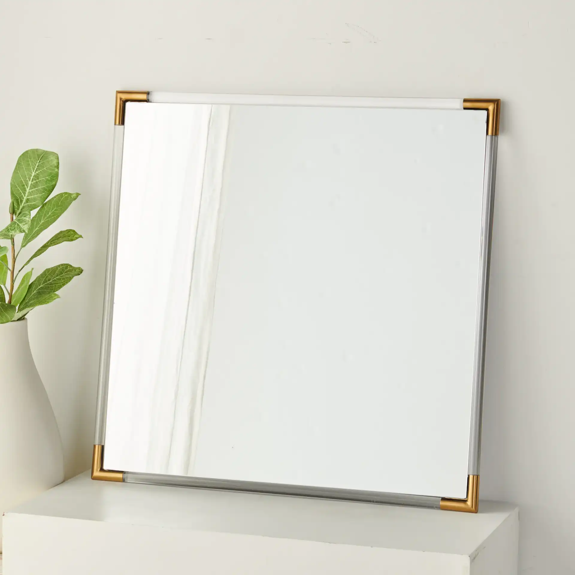 Amina Square Acrylic Mirror in Gold / Clear in a styled room