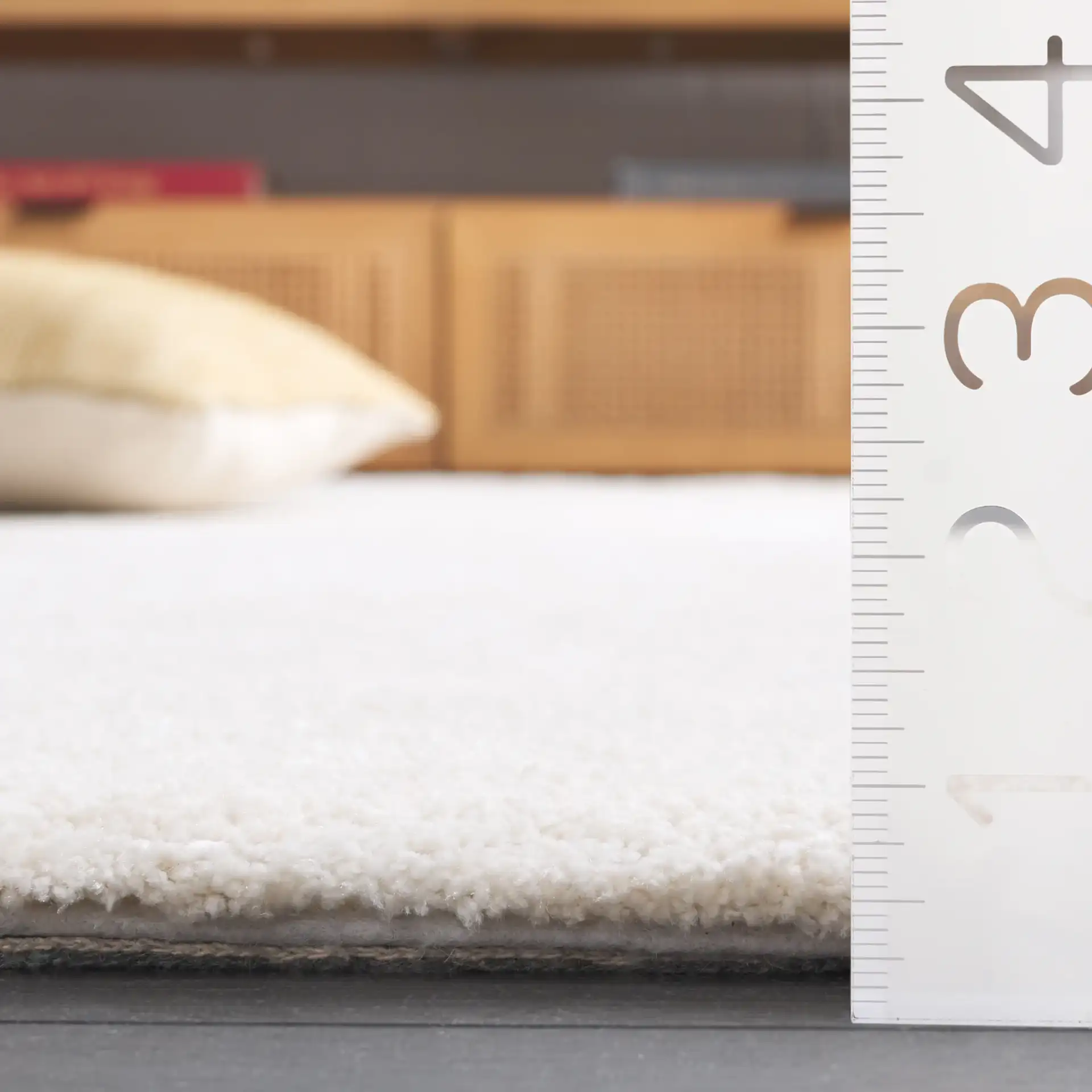 Carmine Ribbed Solid Hand-Tufted Rug in Ivory in a styled room