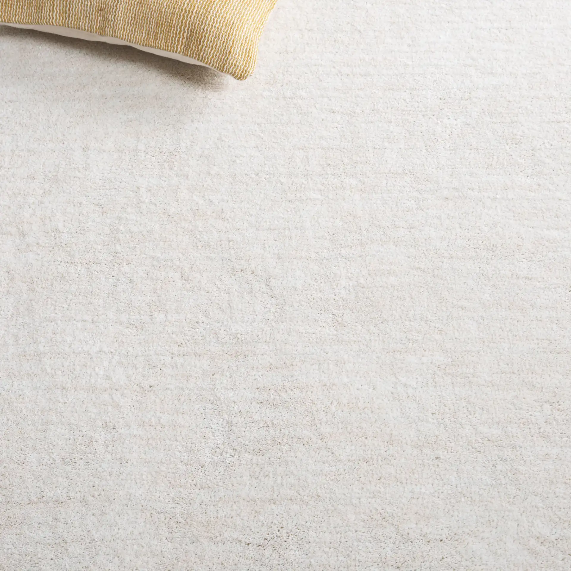 Carmine Ribbed Solid Hand-Tufted Rug in Ivory in a styled room