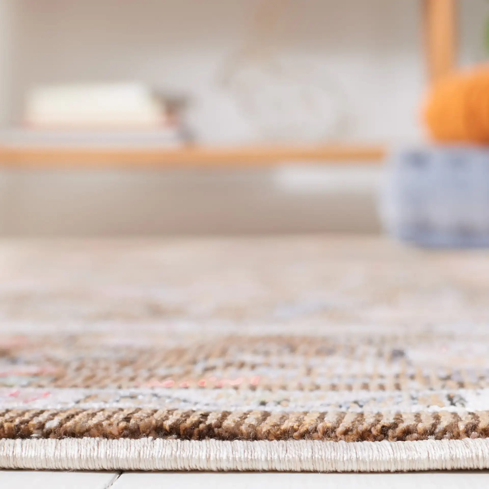 Crimson Floral Border Rug in Brown / Blue in a styled room