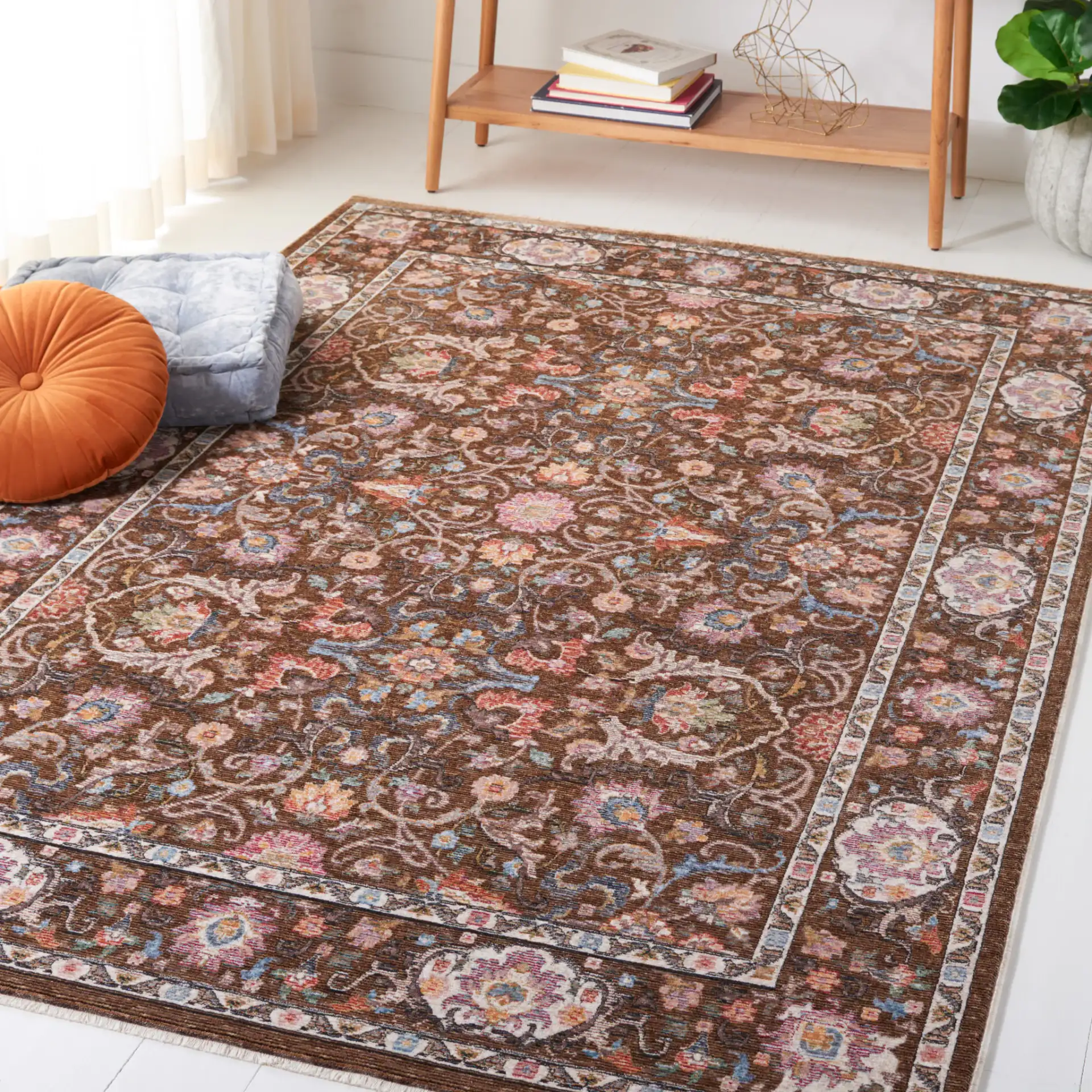 Crimson Floral Border Rug in Brown / Blue in a styled room