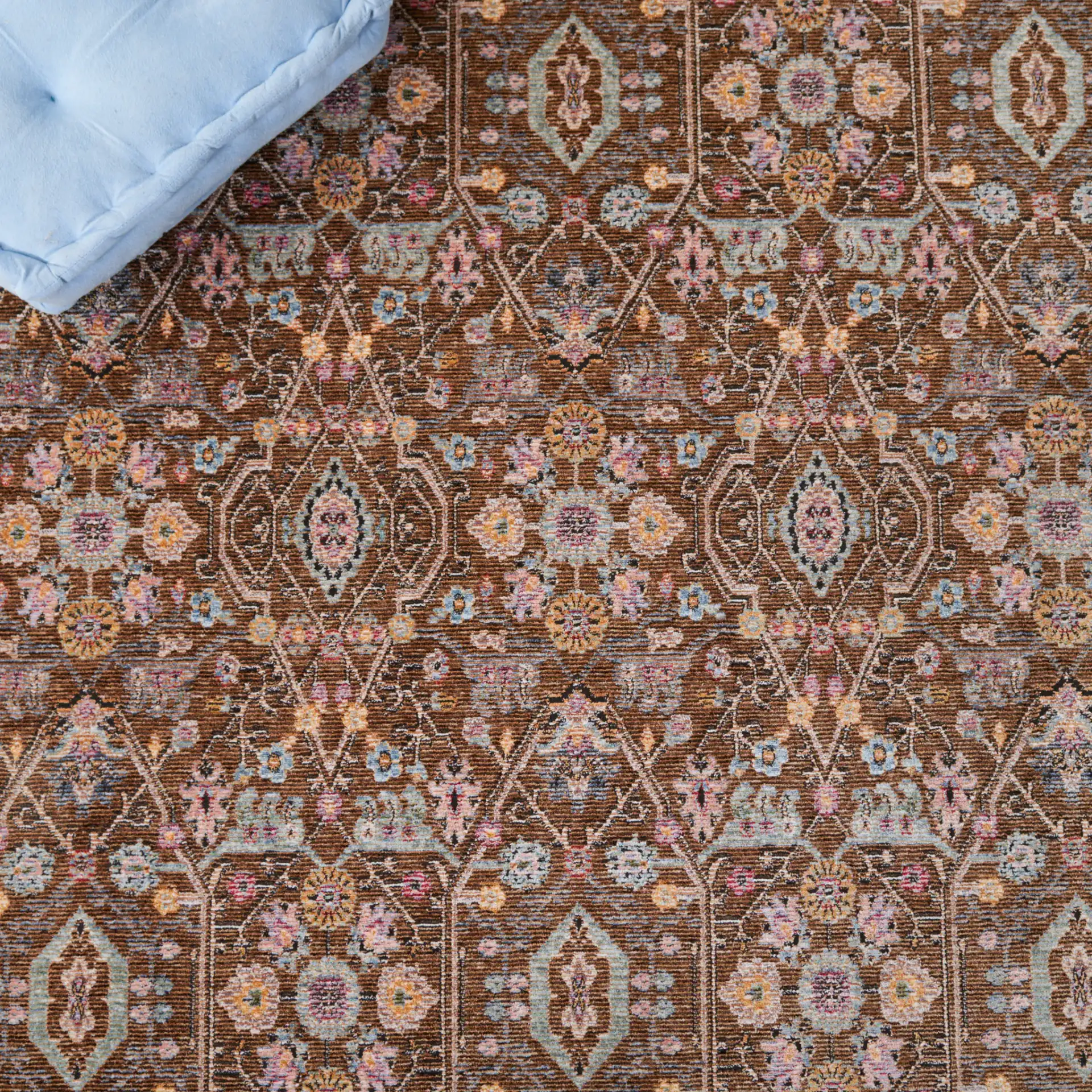 Crimson Floral Lattice Rug in Brown / Blue in a styled room