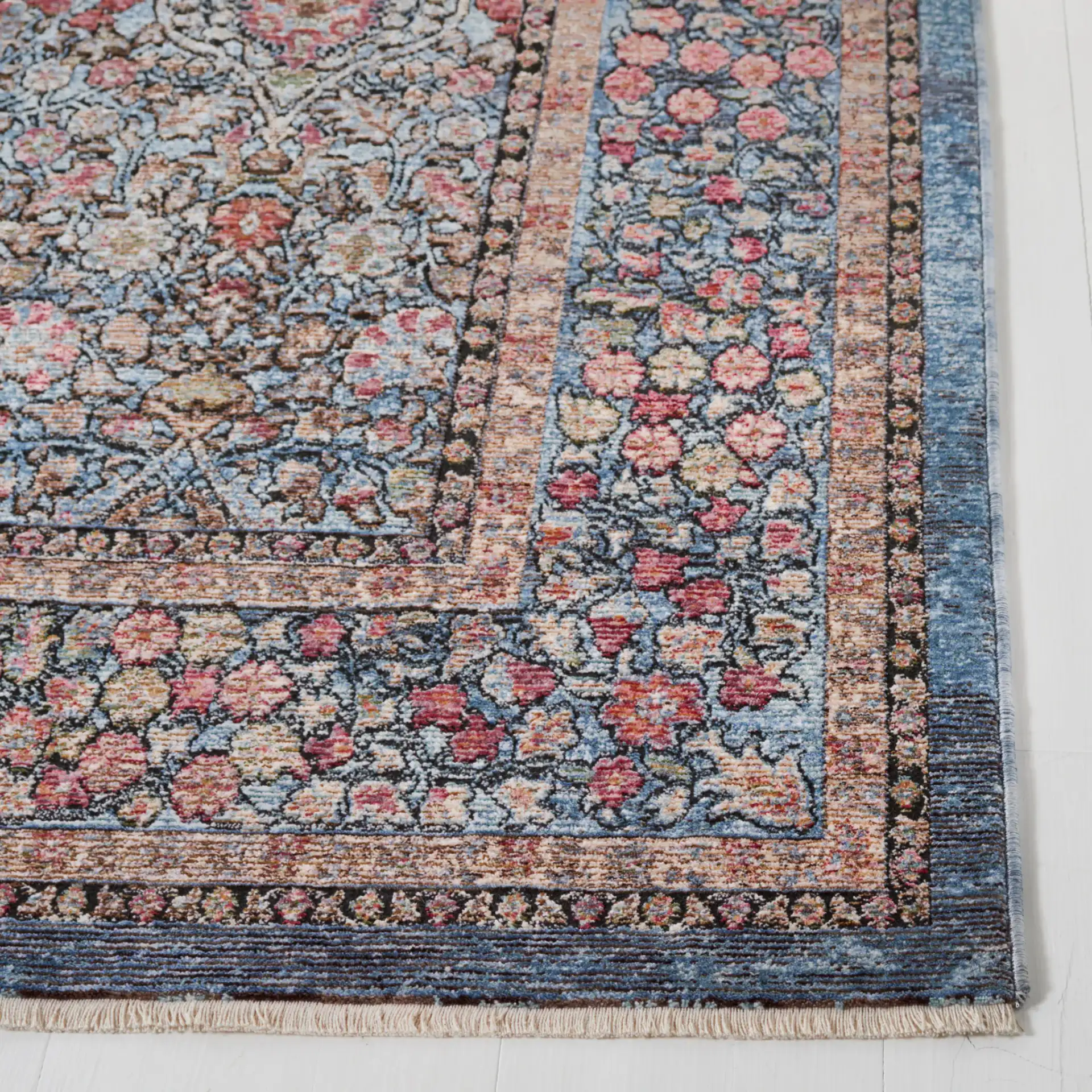 Crimson Bordered Floral Rug in Blue / Black in a styled room