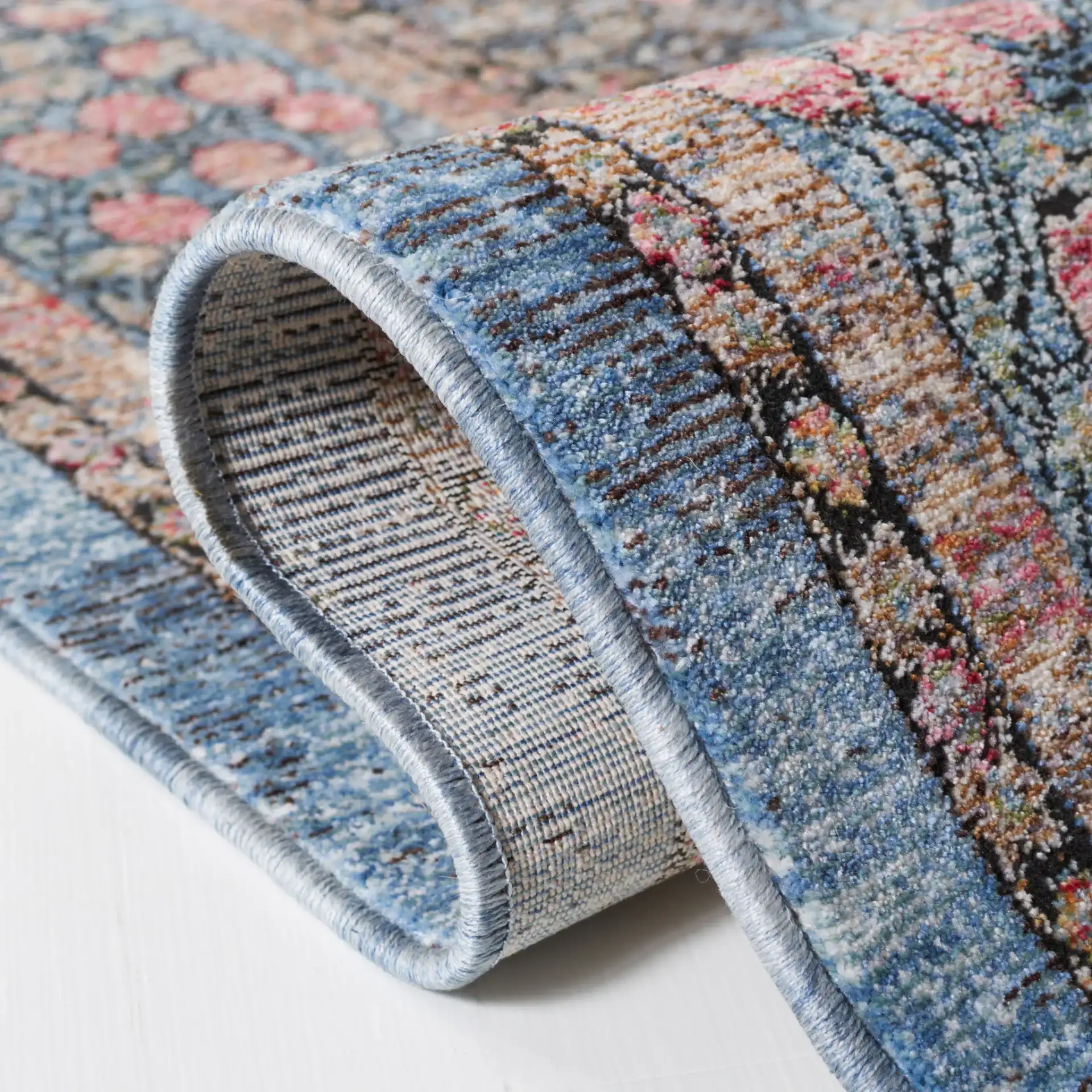 Crimson Bordered Floral Rug in Blue / Black in a styled room