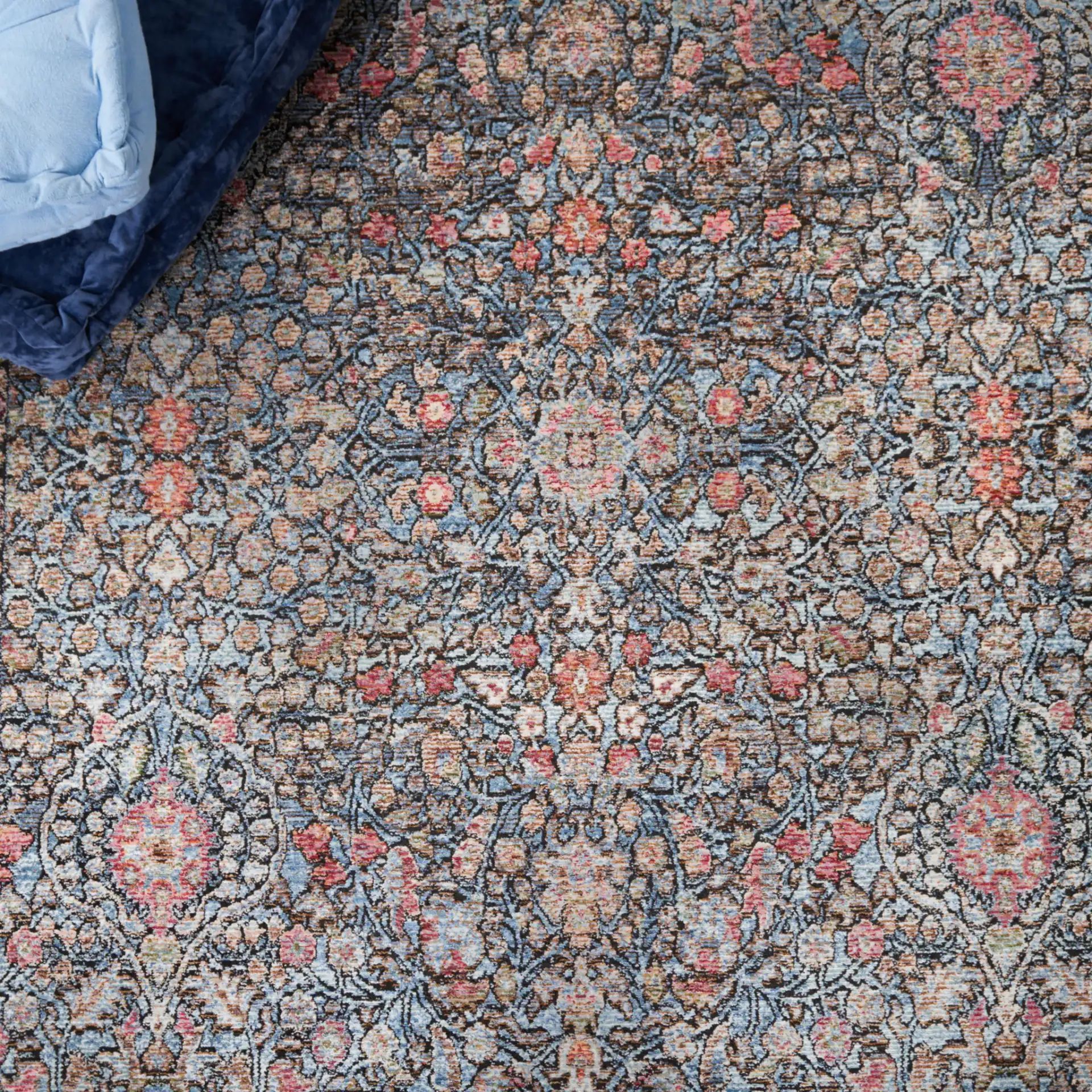 Crimson Bordered Floral Rug in Blue / Black in a styled room