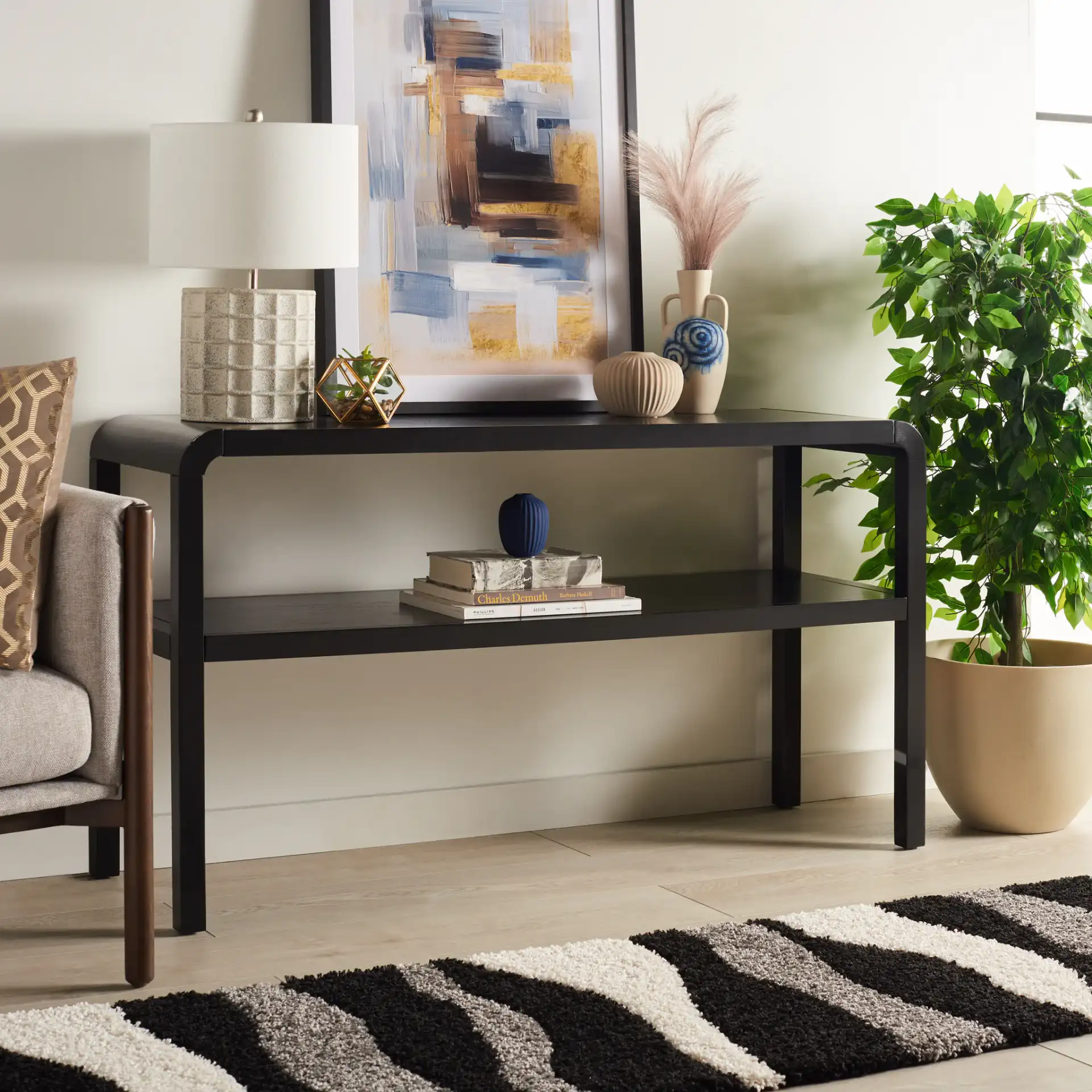 Omara Two-Tier Console Table in Black in a styled room
