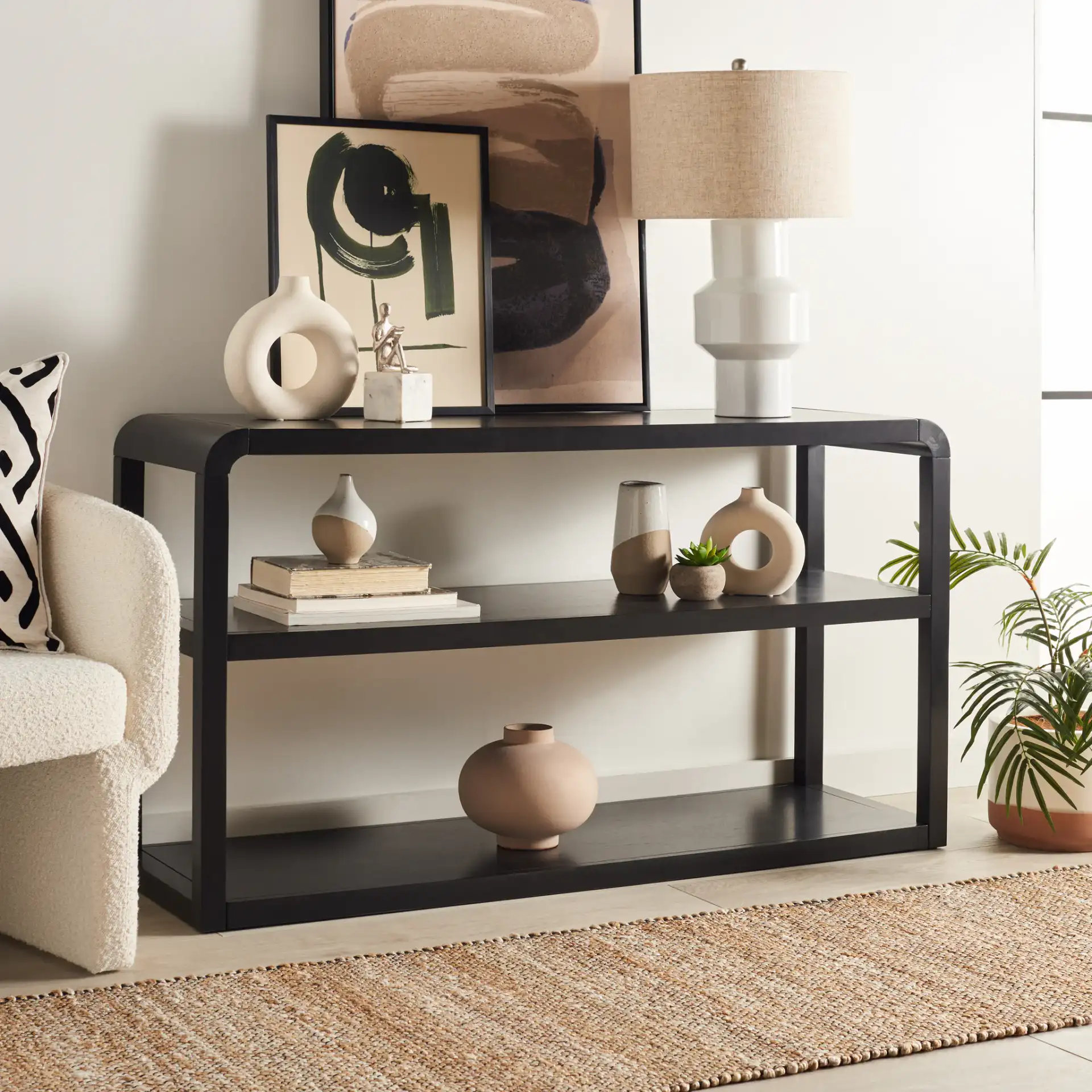 Omara Three-Tier Console Table in Black in a styled room