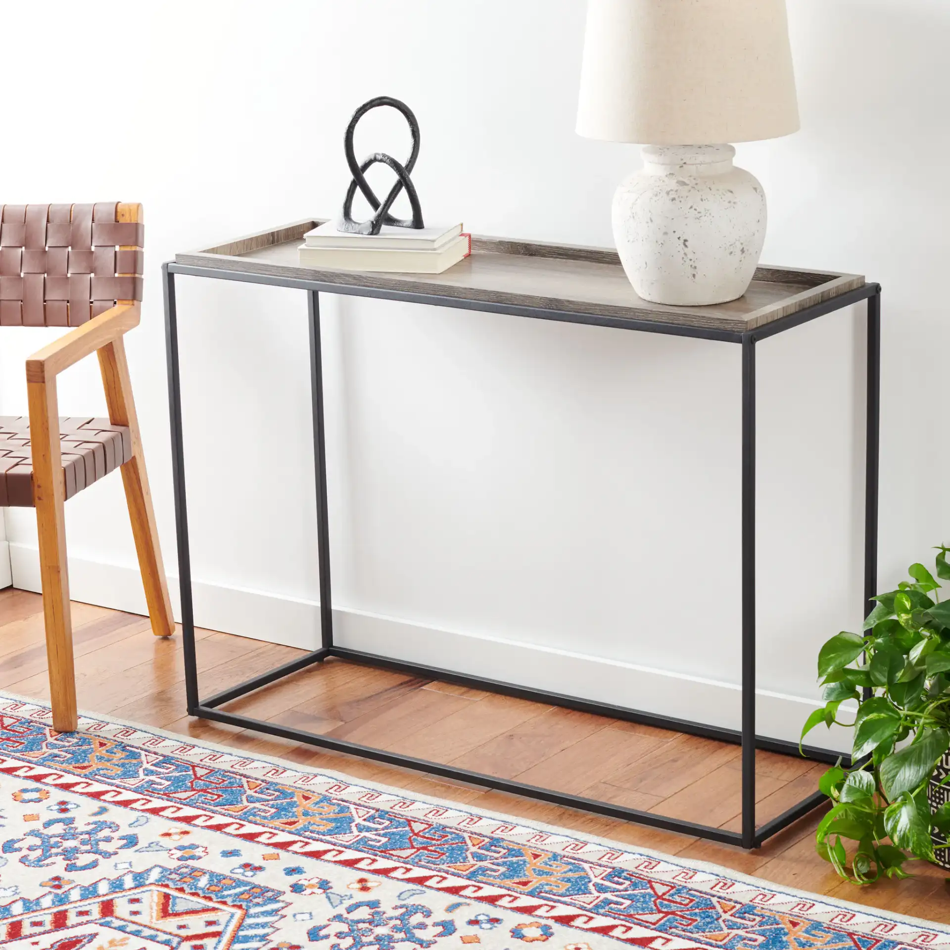 Andey Console Table in Brown / Black in a styled room