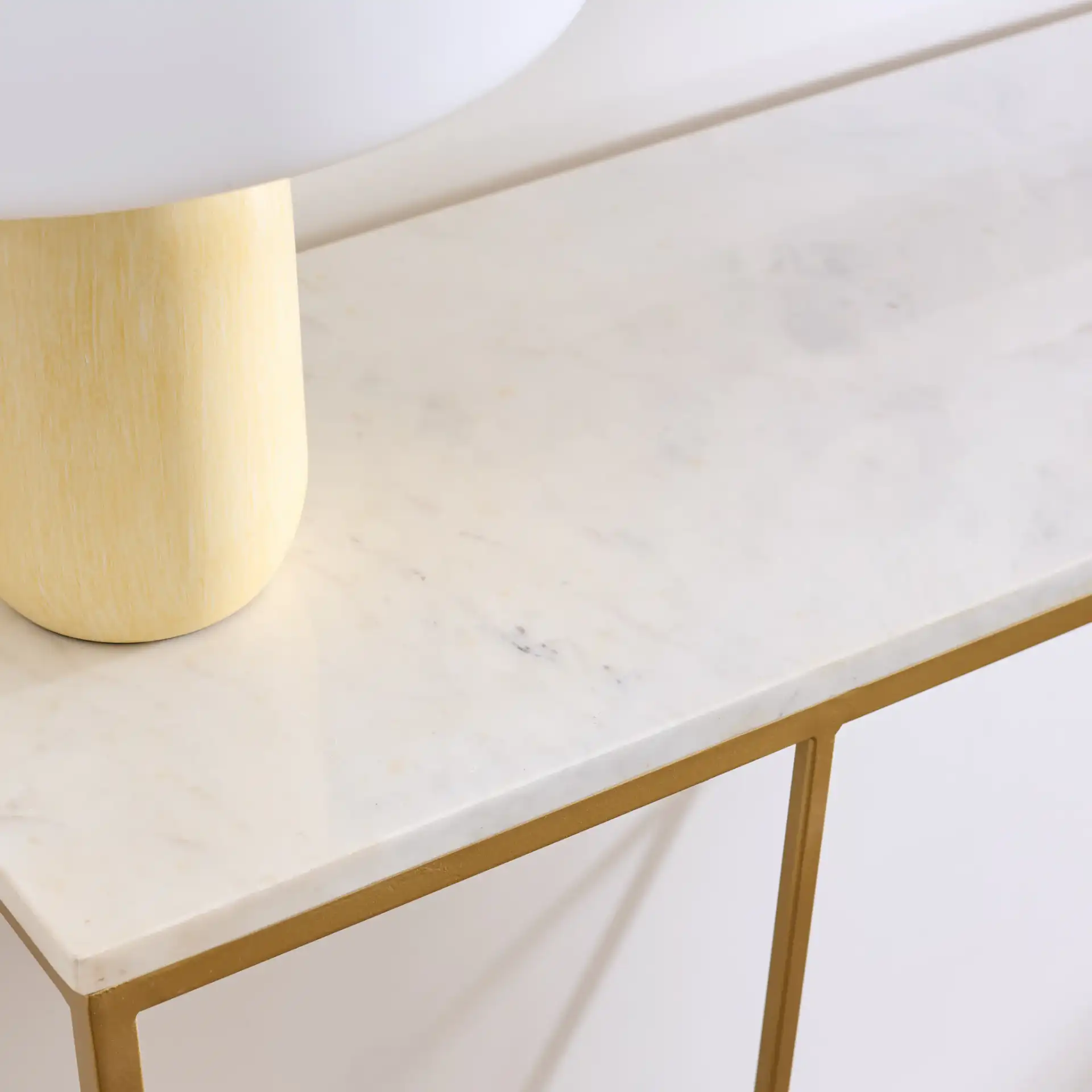 Lumen Marble Console Table in White Marble / Gold in a styled room